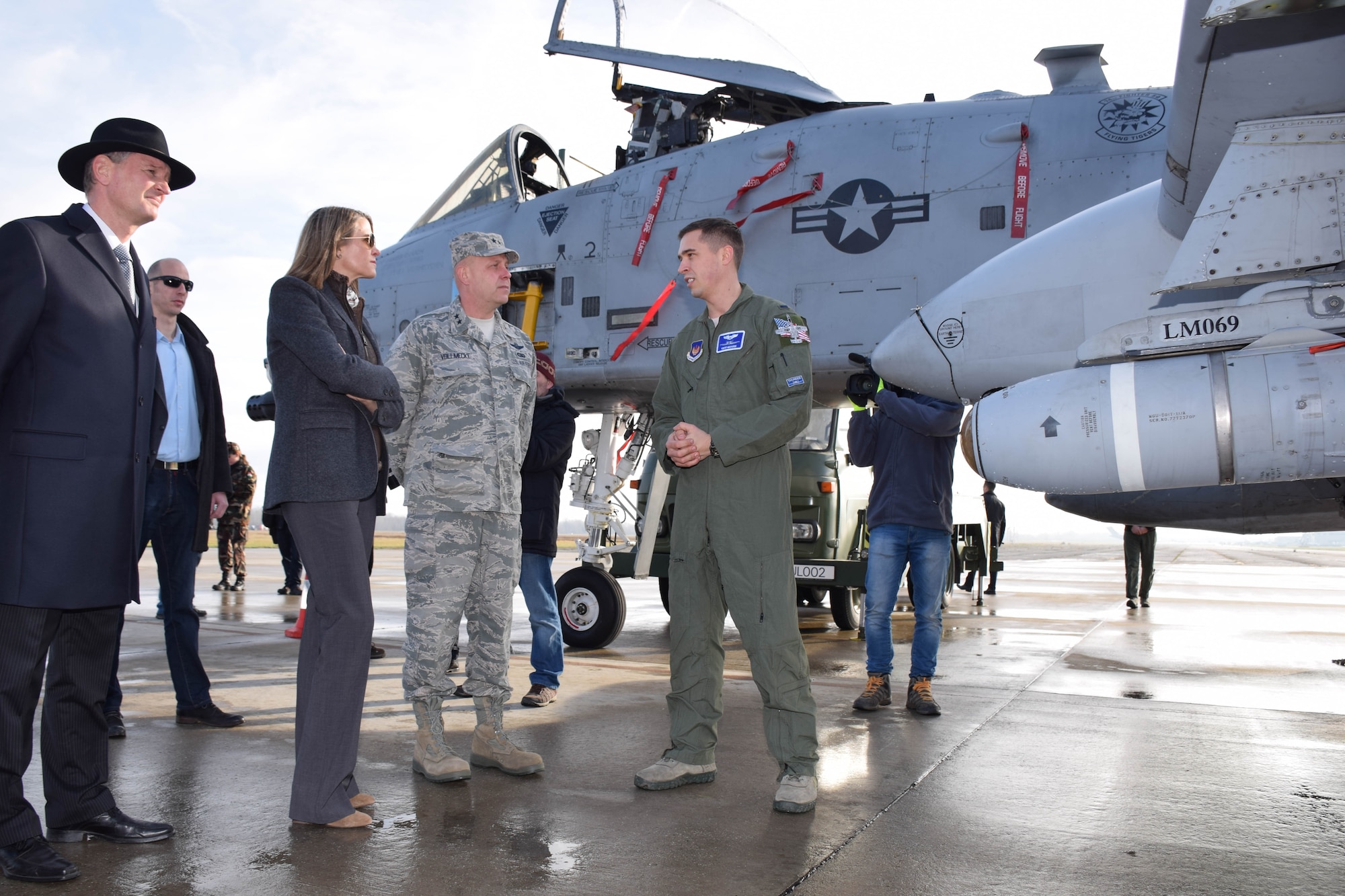 Maj. Gen. Vollmecke receives a briefing on the A-10C Thunderbolt II by 1st Lt. Mecadon of the 74th Expeditionary Fighter Squadron during a visit to Papa Air Base, Hungary, Dec. 2. The 74th EFS forward deployed to Hungary as part of Theater Security Package to conduct training and exercises alongside the Hungarian Air Force to increase readiness and enhance interoperability. Vollmecke was accompanied by U.S. Ambassador to Hungary, Colleen Bell and Mr. Peter Siklosi, the Hungarian MoD Deputy State Secretary for Defense Policy and Defense Planning, (U.S. Air Force photo/ Capt. Lauren Ott)