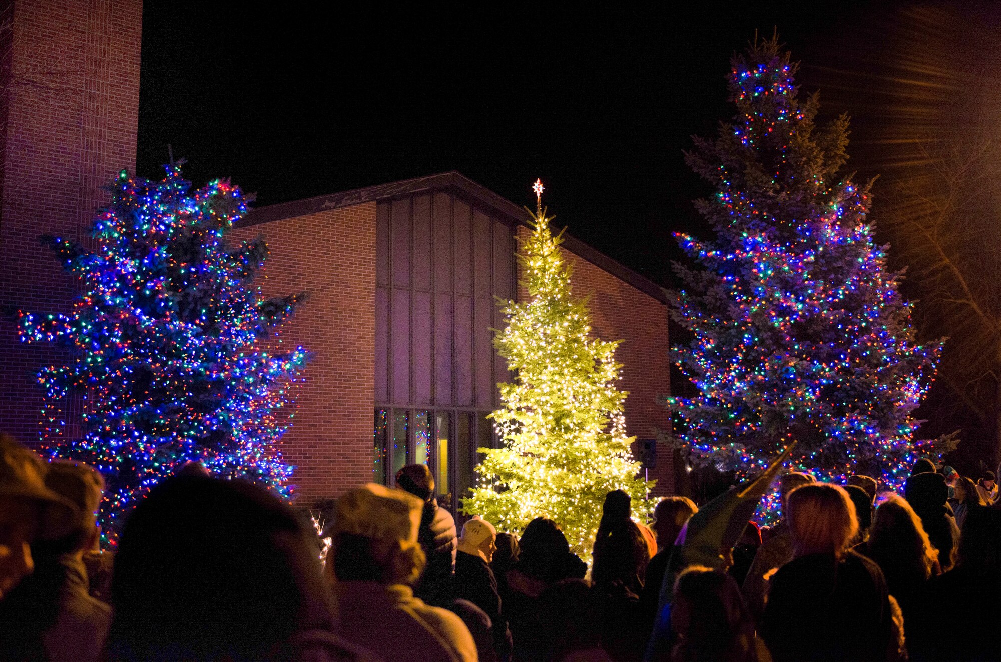 Trees adorned with holiday lights glow at the annual tree lighting ceremony at Minot Air Force Base, N.D., Dec. 2, 2015. The event offered an opportunity for Airmen and their families to enjoy the holidays together. (U.S. Air Force photo/Airman 1st Class J.T. Armstrong)