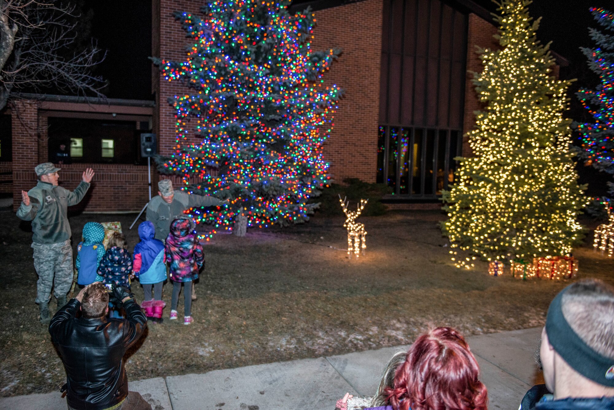 Col. Jason Armagost, 5th Bomb Wing commander, and Col. Michael Lutton, 91st Missile Wing commander, flip the switch during the annual tree lighting ceremony at Minot Air Force Base, N.D., Dec. 2, 2015. The event offered an opportunity for Airmen and their families to enjoy the holidays together. (U.S. Air Force photo/Airman 1st Class J.T. Armstrong)