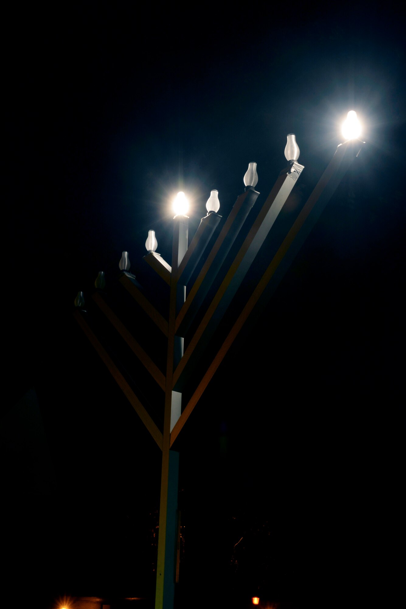 A menorah glows after a Hanukkah menorah lighting ceremony Dec. 6, 2015, in front of the base chapel on RAF Mildenhall, England. The Hanukkah menorah lighting ceremony is one of the many holiday observances hosted by RAF Mildenhall. (U.S. Air Force photo by Staff Sgt. Micaiah Anthony/Released)