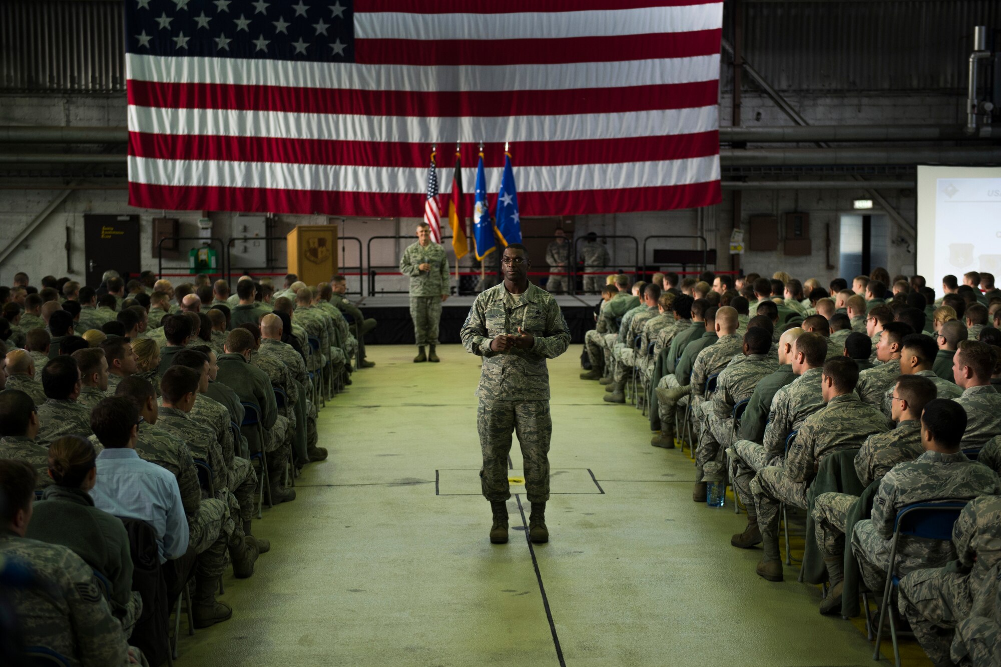 U.S. Air Force Chief Master Sgt. James Davis, U.S. Air Forces in Europe and Air Forces in Africa command chief, listens to a question during an all call inside Hangar 1 at Spangdahlem Air Base, Germany, Dec. 3, 2015. Davis and U.S. Air Force Gen. Frank Gorenc, USAFE-AFAFRICA commander, finished up the all call by answering any questions Airmen had. (U.S. Air Force photo by Airman 1st Class Luke Kitterman)