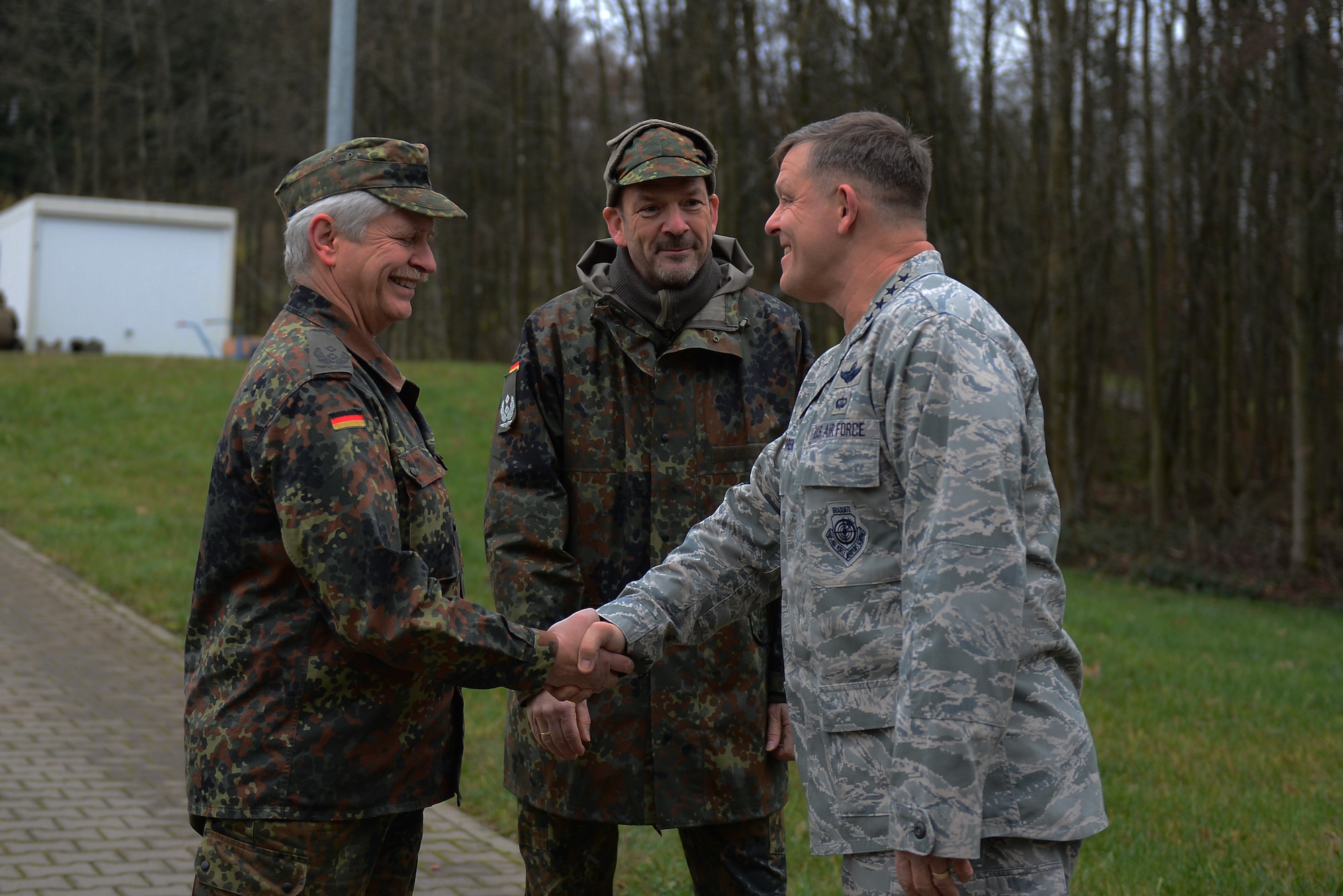 U.S. Air Force Gen. Frank Gorenc, U.S. Air Forces in Europe and Air Forces Africa commander, right, shakes hands with German air force leaders at the 702nd Munitions Support Squadron in Buechel, Germany, Dec. 3, 2015. Gorenc and U.S. Air Force Chief Master Sgt. James Davis, USAFE- AFAFRICA command chief, provided an all call for Airmen assigned at the 702nd MUNSS. (U.S. Air Force photo by Airman 1st Class Luke Kitterman)
