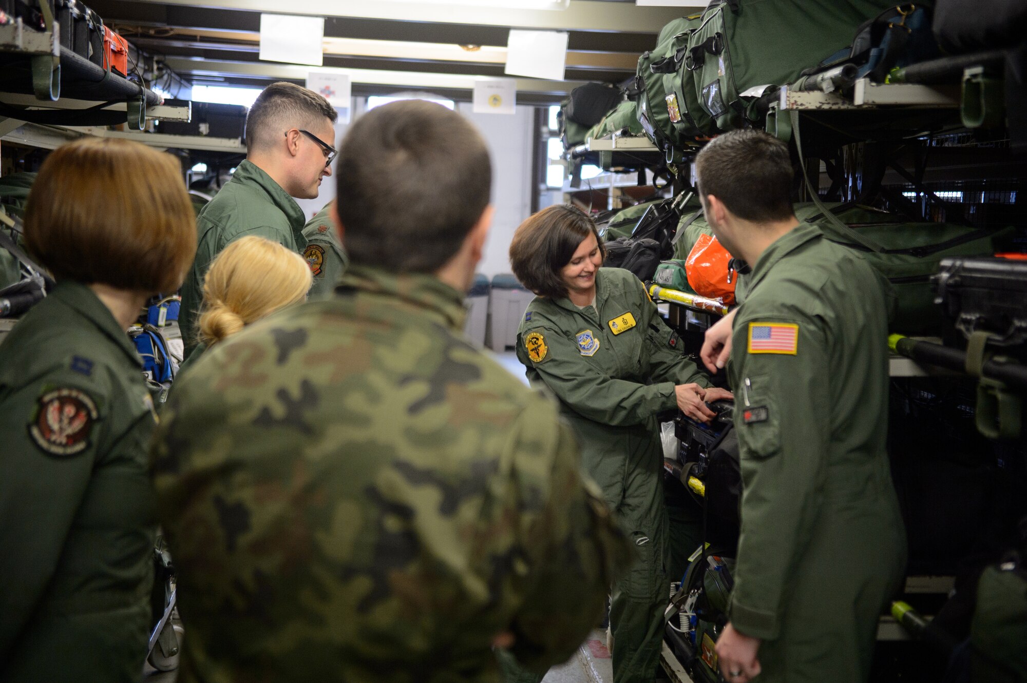 U.S. Air Force Capt. Tina Coughlin, 10th Expeditionary Aeromedical Evacuation Flight critical care air transport team member, showcases equipment and procedures used by the 10th EAEF Dec. 2, 2015, at Ramstein Air Base, Germany. During a visit to the 10th EAEF, Polish aeromedical evacuation specialist saw the 10th EAEF and 86th Aeromedical Evacuation Squadron in action as they took care of wounded warriors. (U.S. Air Force photo/Staff Sgt. Armando A. Schwier-Morales)
