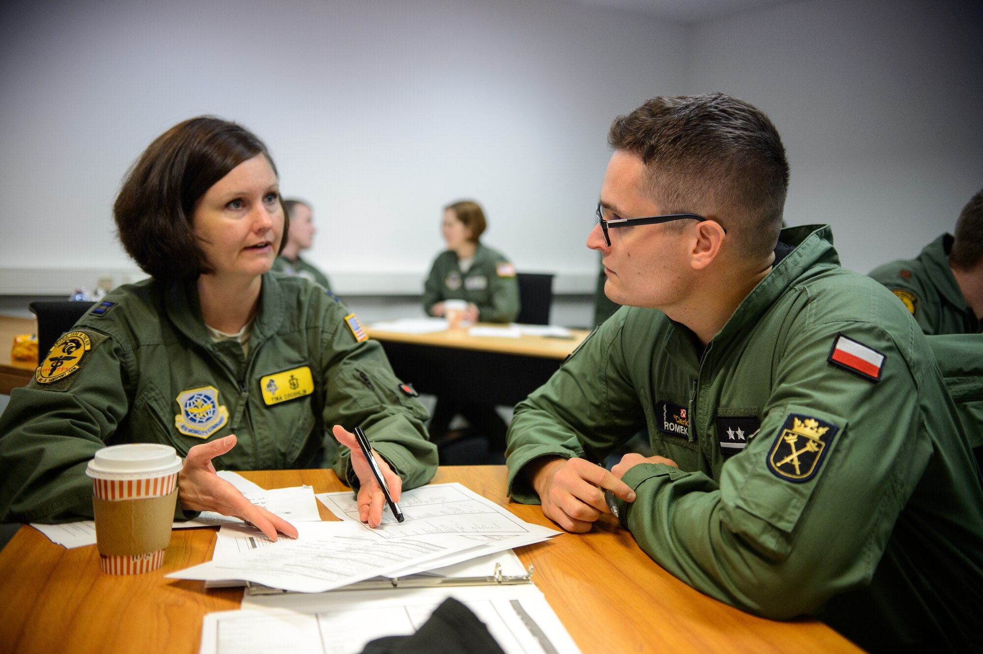 U.S. Air Force Capt. Tina Coughlin, 10th Expeditionary Aeromedical Evacuation Flight critical care air transport team member, showcases equipment and procedures used by the 10th EAEF Dec. 2, 2015, at Ramstein Air Base, Germany. During a visit to the 10th EAEF, Polish aeromedical evacuation specialist saw the 10th EAEF and 86th Aeromedical Evacuation Squadron in action as they took care of wounded warriors. (U.S. Air Force photo/Staff Sgt. Armando A. Schwier-Morales)