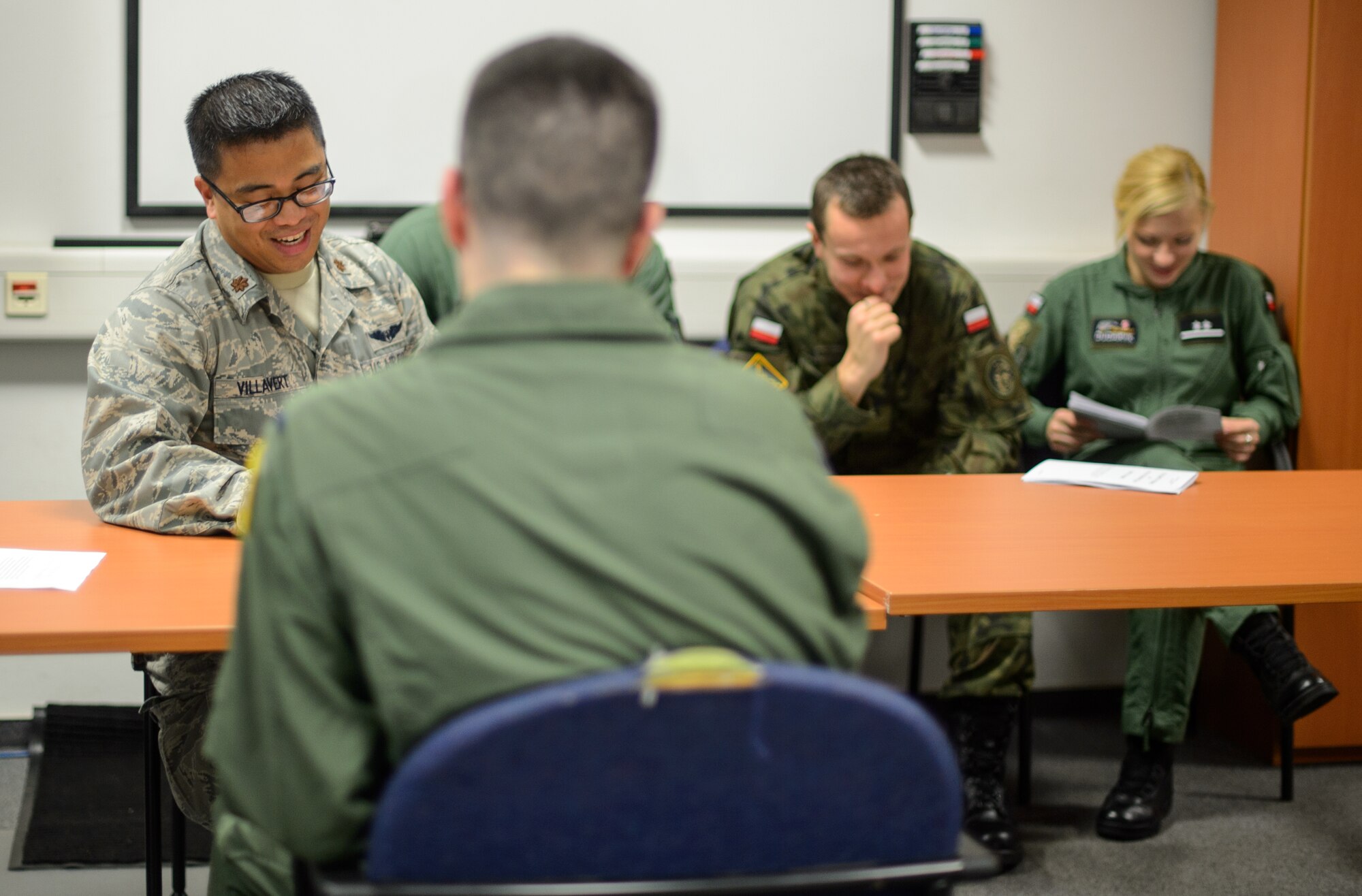 U.S. Air Force Maj. Joel Villavert, 86th Aeromedical Evacuation Squadron flight nurse examiner, Polish air force 2nd Lts. Andrzej Nartonowicz, aeromedical evacuation doctor, and Marzena Dudaryk, aeromedical evacuation paramedic, read an evaluation checklist during a familiarization tour Dec. 1, 2015, at Ramstein Air Base, Germany.  U.S. Air Forces in Europe and Air Forces Africa hosted the team for a four-day visit to see how the Air Force conducts their missions. (U.S. Air Force photo/Staff Sgt. Armando A. Schwier-Morales)