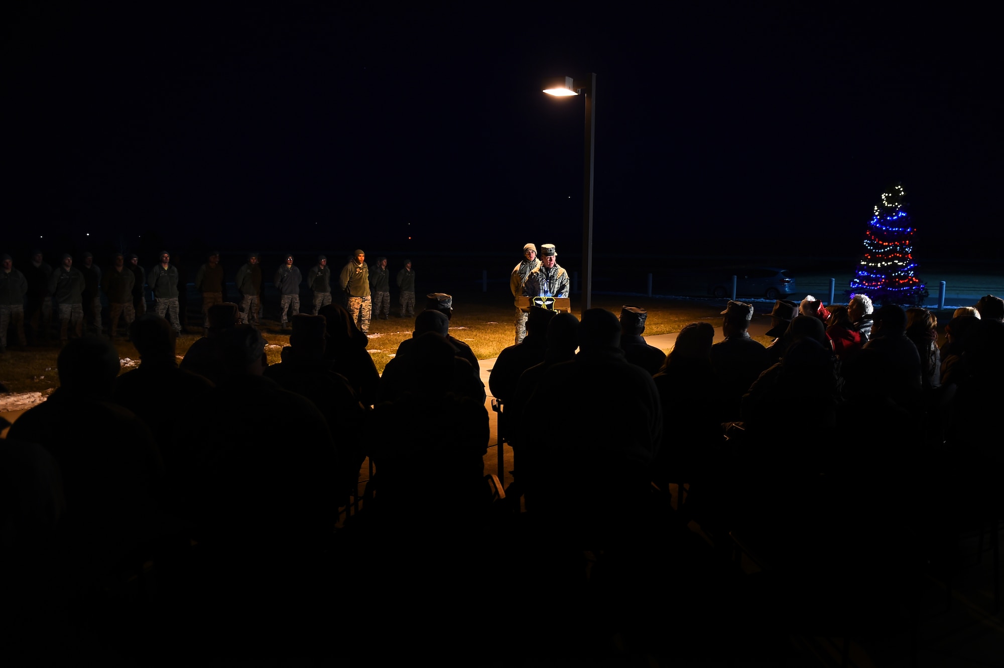 Lt. Col. Christopher Kennedy, 460th Space Communications Squadron commander, speaks during a tree-lighting ceremony Dec. 3, 2015, on Buckley Air Force Base, Colo. The ceremony takes place every year to honor Senior Airman Kristopher Mansfield, who was killed in a drunk driving accident in 2004. (U.S. Air Force photo by Airman First Class Gabrielle Spradling/Released)