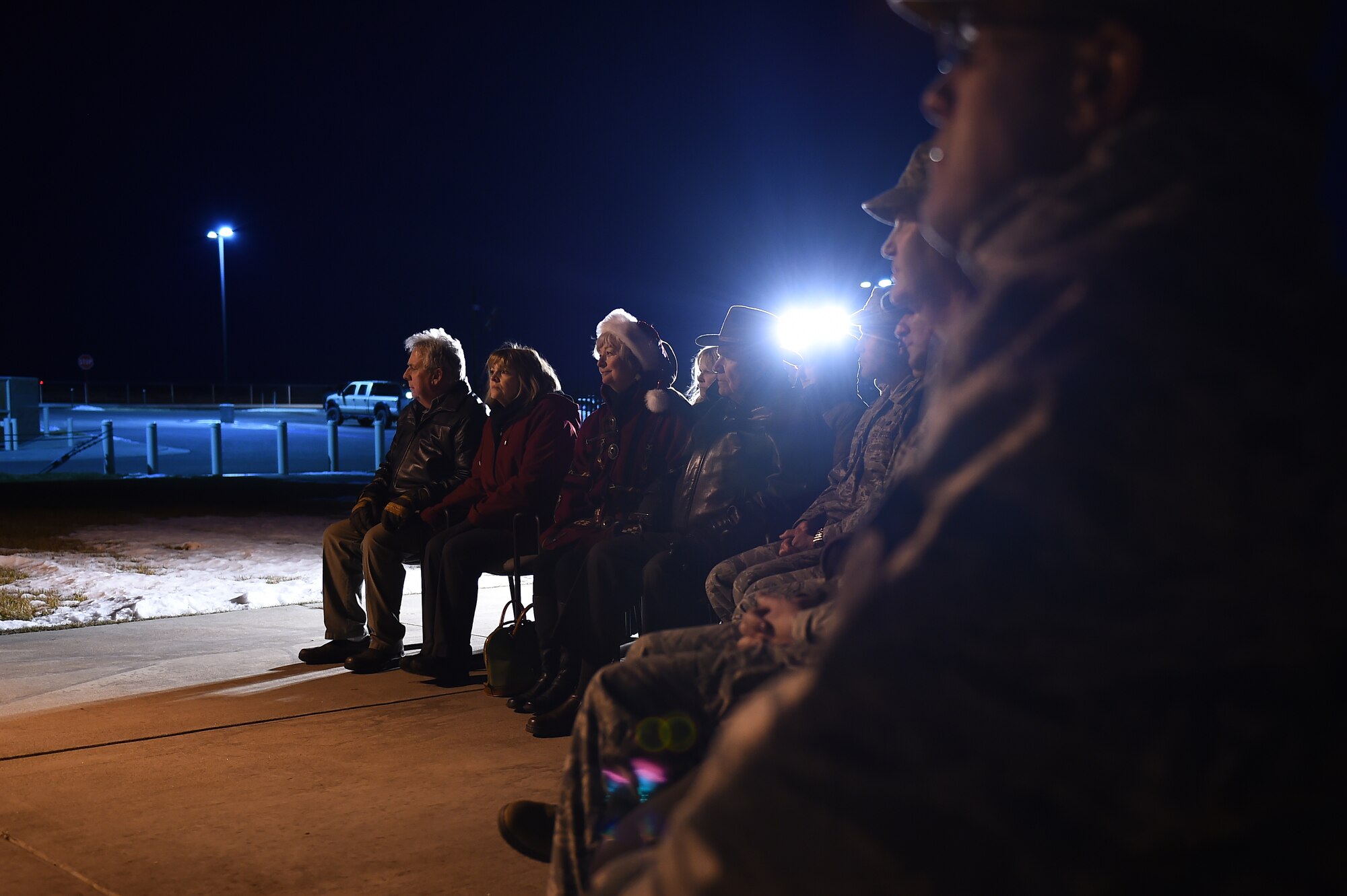 Team Buckley members observe a tree-lighting ceremony Dec. 3, 2015, on Buckley Air Force Base, Colo. The ceremony takes place every year to honor Senior Airman Kristopher Mansfield, who was killed in a drunk driving accident in 2004. (U.S. Air Force photo by Airman First Class Gabrielle Spradling/Released)