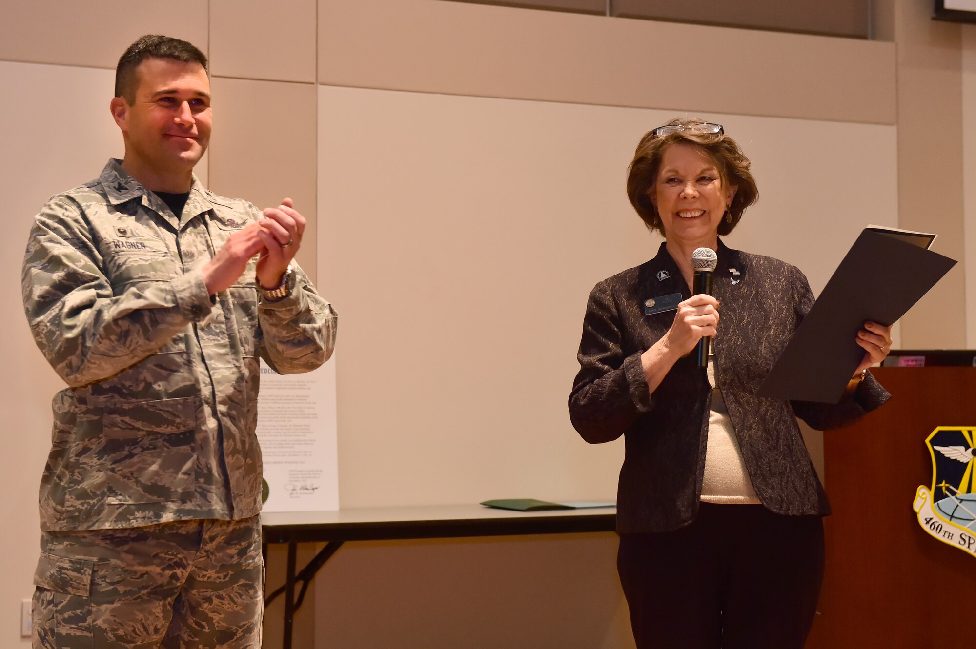 Su Ryden, State Representative District 36, reads the Space-based Missile Warning Day proclamation with Col. John Wagner, 460th Space Wing commander, Dec. 4, 2015, at the Leadership Development Center on Buckley Air Force Base, Colo. John W. Hickenlooper, Colorado governor, proclaimed that Dec. 4 will now and forever be Space-based Missile Warning Day in the State of Colorado. (U.S. Air Force photo by Airman 1st Class Luke W. Nowakowski/Released)
