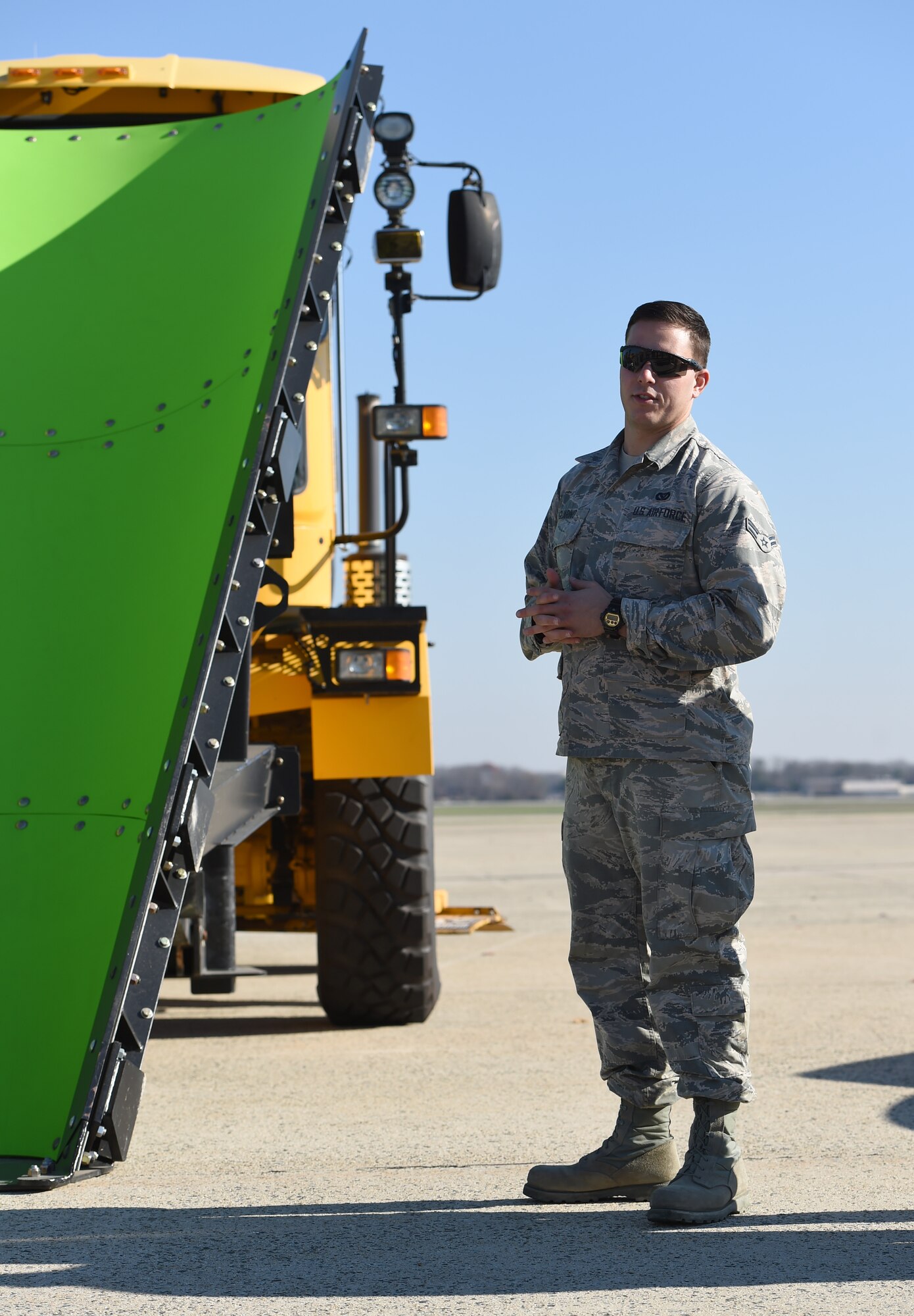 Airman 1st Class Mark Guarnio, 11th Civil Engineer Squadron heavy equipment operator, briefs snow removal operations during the 11th CES’s Snow Parade, Dec. 4, 2015 at Joint Base Andrews, Md. The parade was held to recognize some of the key mission-essential workers during the snow removal season. (U.S. Air Force photo/ Senior Airman Nesha Humes/ released)
