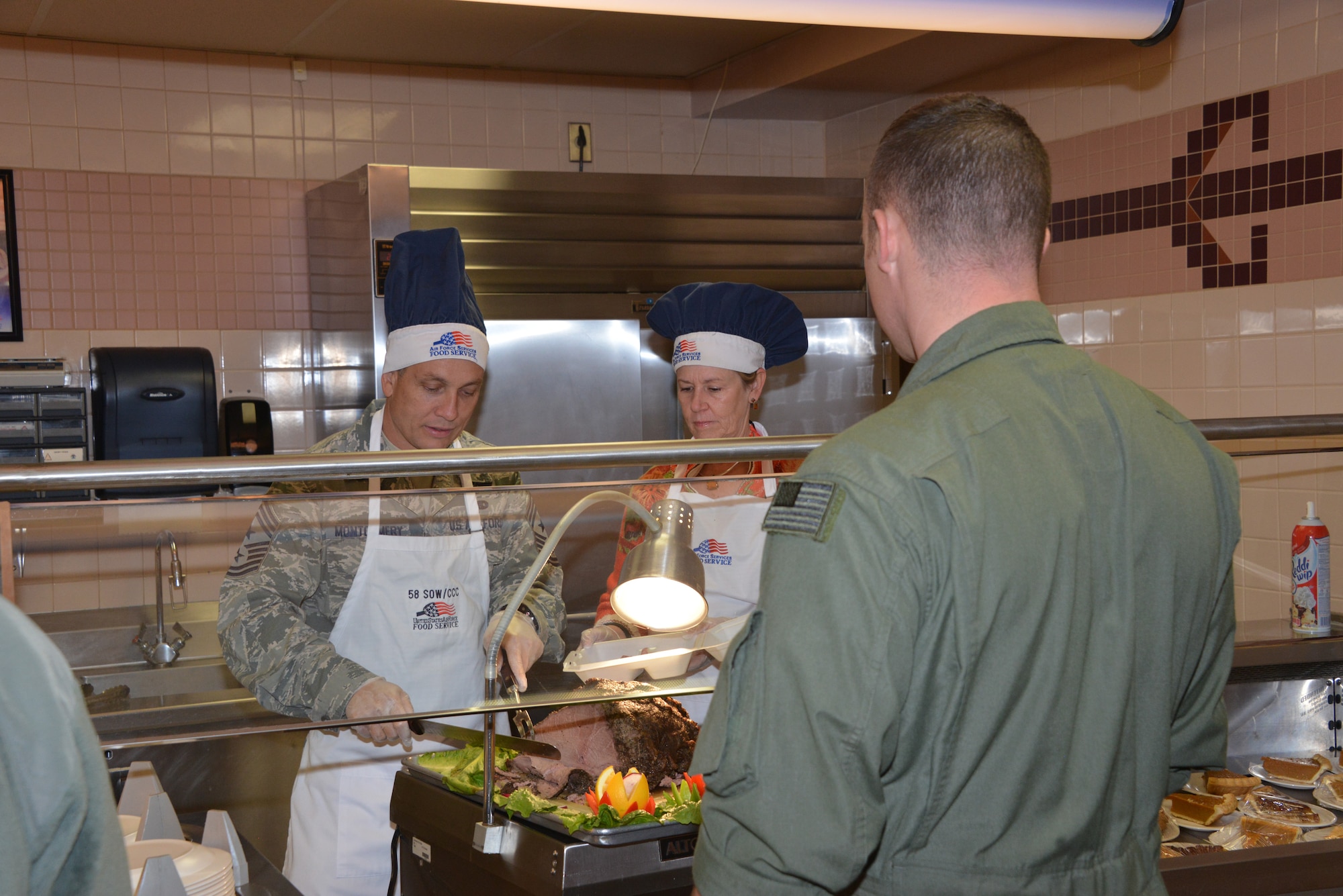 Commanders, chiefs, first sergeants and their spouses served a Thanksgiving meal at Thunderbird Inn Dining Facility on Thanksgiving Day. (Photo by Dennis Carlson) 