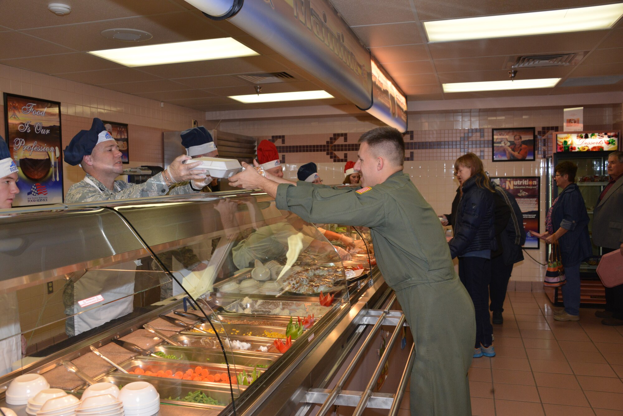 Commanders, chiefs, first sergeants and their spouses served a Thanksgiving meal at Thunderbird Inn Dining Facility on Thanksgiving Day. (Photo by Dennis Carlson) 