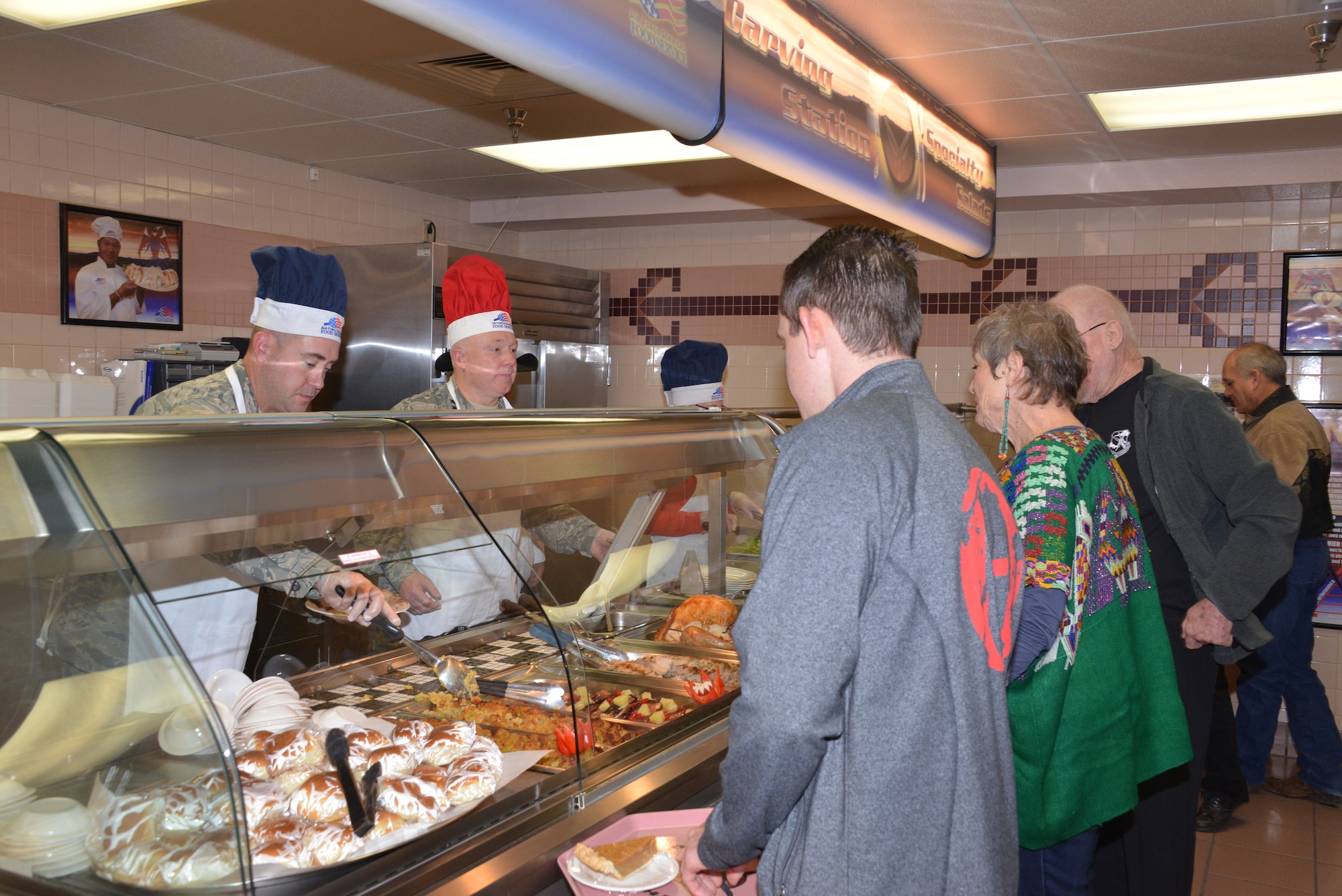 Commanders, chiefs, first sergeants and their spouses served a Thanksgiving meal at Thunderbird Inn Dining Facility on Thanksgiving Day. (Photo by Dennis Carlson) 