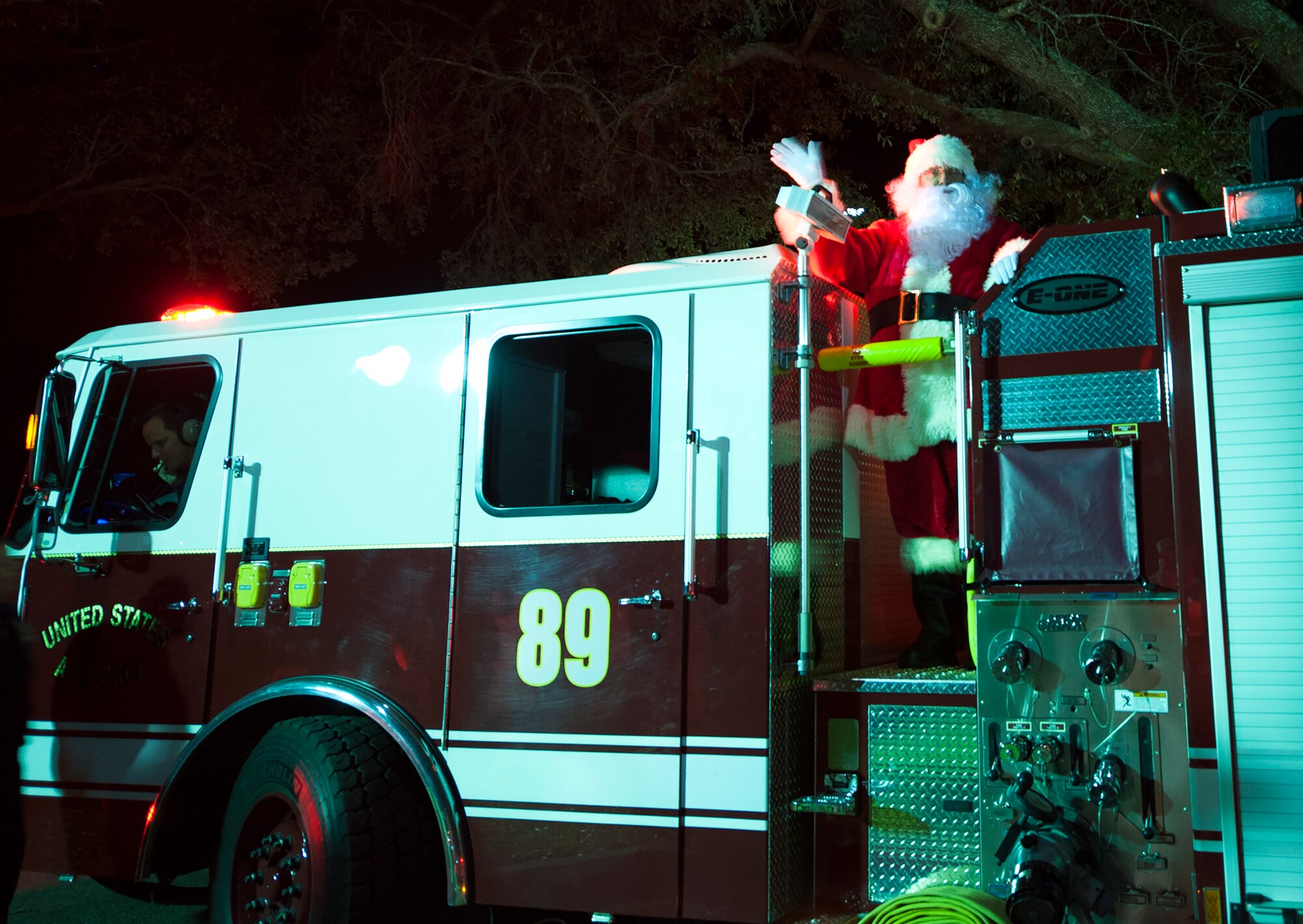 Santa Claus arrives by fire truck at the West Gate Chapel during the Christmas tree lighting festivities Dec. 4 at Eglin Air Force Base, Fla. Santa Claus attended the Chapel’s holiday reception to hear the children’s Christmas wishes following the tree lighting. (U.S. Air Force photo/Ilka Cole)