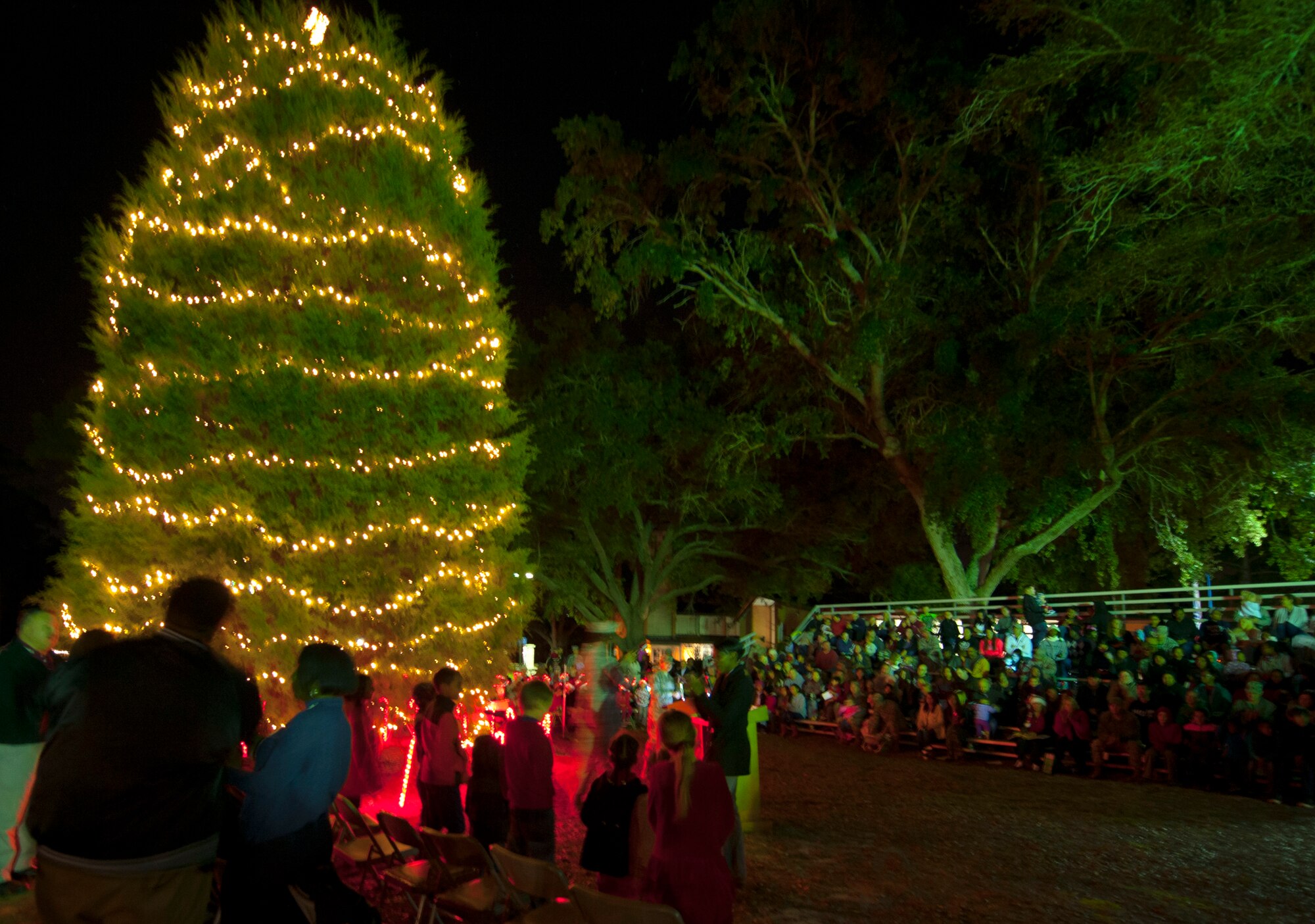 Families gather around to see the base’s tree lighting festivities at the West Gate Chapel Dec. 4 at Eglin Air Force Base, Fla. Following the tree lighting, Santa Claus arrived by fire truck to hear the children’s Christmas wishes during the Chapel’s reception. (U.S. Air Force photo/Ilka Cole)