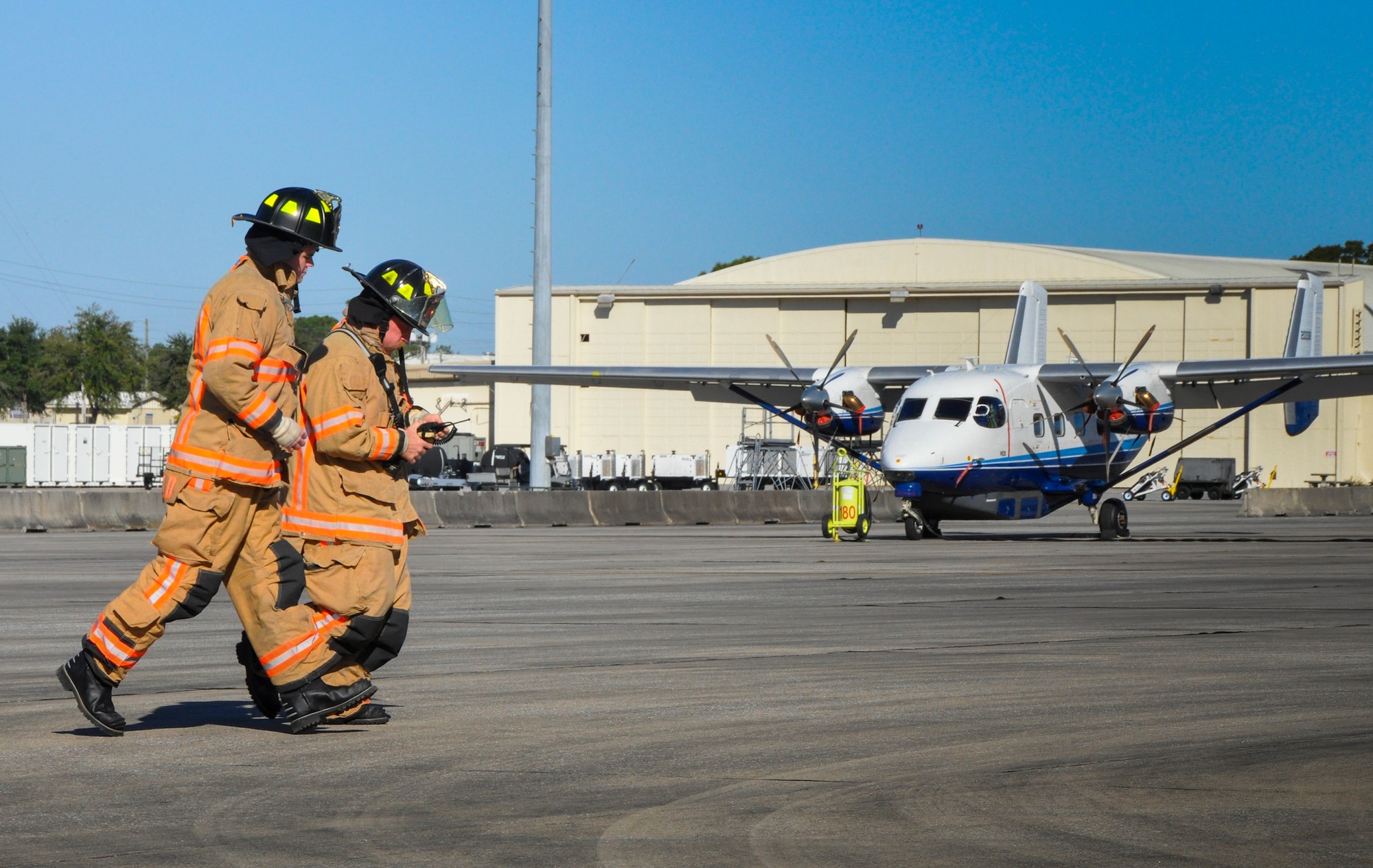 The 96th Test Wing firefighters move toward the scene during an anti-hijacking exercise Dec. 7 at Duke Field, Fla.  Test wing security forces and firefighters were called upon to stop the attack, secure the scene and provide assistance to the simulated victims.  The exercise was part of the overall Air Force Reserve Command Unit Effectiveness Inspection of the 919th Special Operations Wing Dec. 3-8, which highlighted a new process for evaluating mission readiness.  (U.S. Air Force photo/Dan Neely)