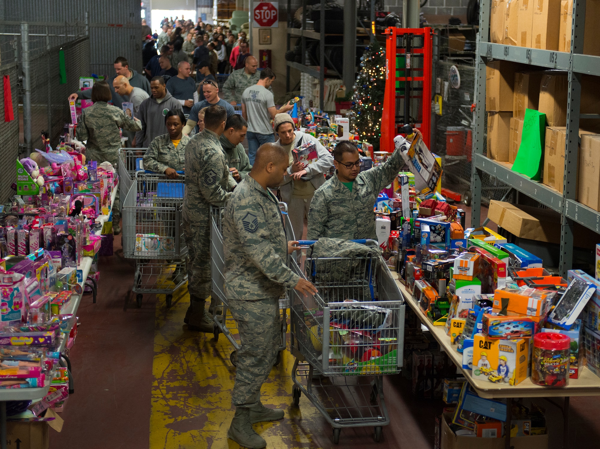 First sergeants escort Airmen through the annual holiday toy distribution at Eglin Air Force Base, Fla., Dec. 4.  Approximately 2,000 toys were collected by donations made throughout the year. Toys, bikes, books, games, crafts, sports equipment and stuffed animals were given to active-military families in need of assistance during the holidays.  (U.S. Air Force photo/Samuel King Jr.)