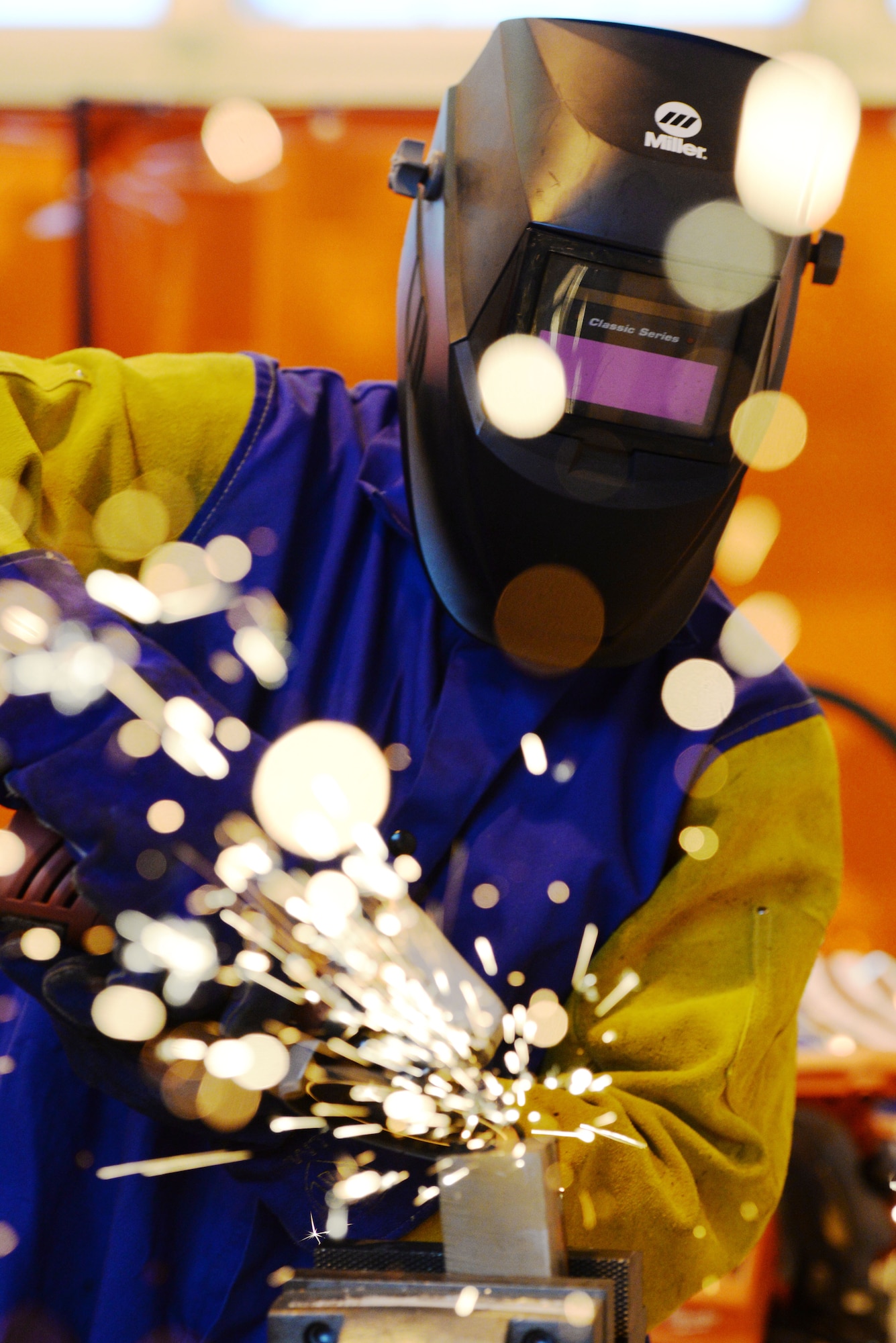 A welder with the Rapid Development Integration Facility grinds down some metal while working on a project inside their 20,000 square-foot manufacturing and modification facility at Wright-Patterson Air Force Base, Ohio, Dec. 2, 2015. Since their start, the RDIF has has been able to successfully return more than $150 million to their customers who could then use that money on additional projects. Additionally, they have been able to help their customers realize more than 70 percent cost savings and schedule time. (U.S. Air Force photo/Wesley Farnsworth.)