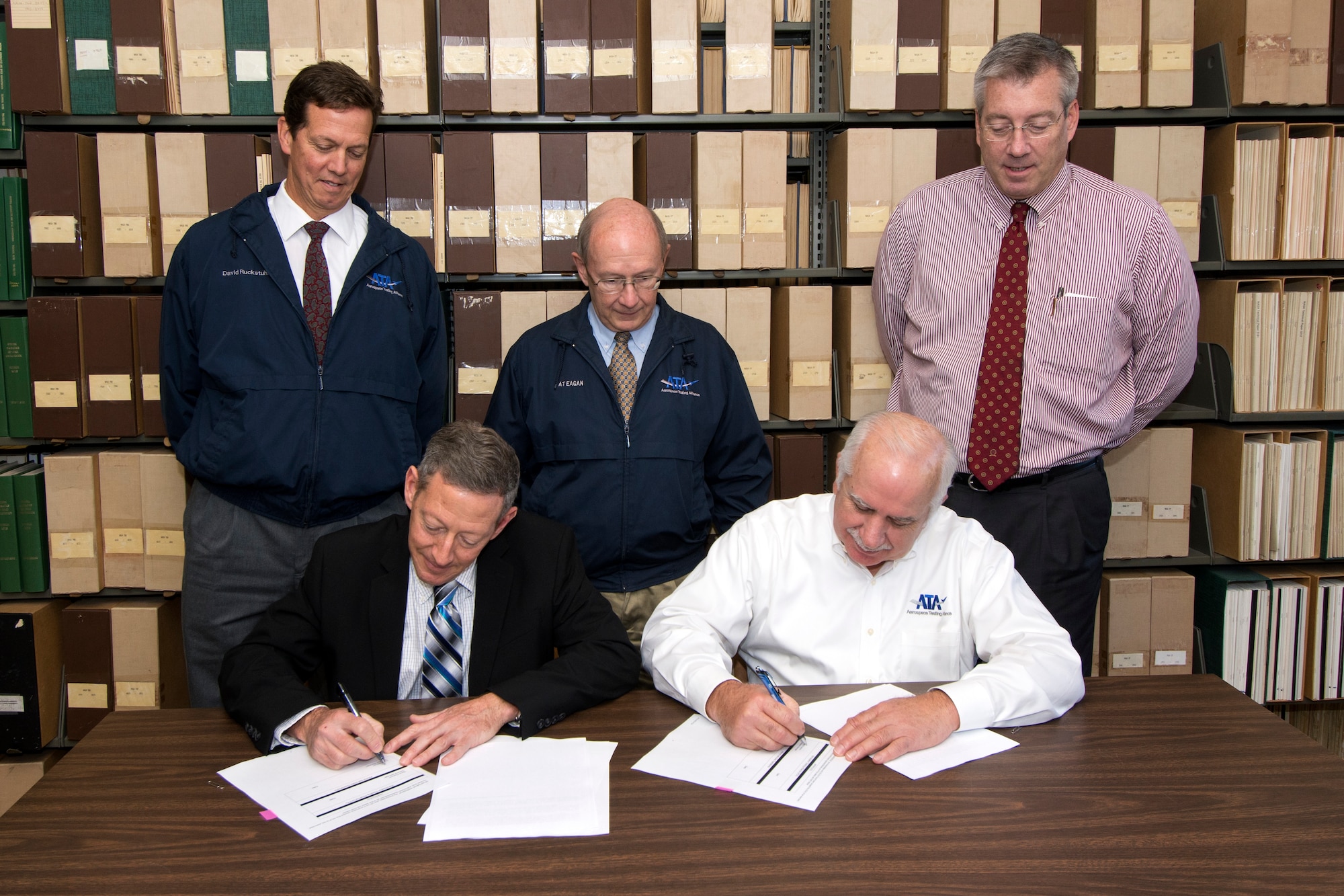 Akima Support Operations, LLC Project Manager Eugene Mittuch (seated left) and ATA General Manager Steve Pearson (seated right) sign the ATA/ASO Associate Contractor Agreement on Nov. 19, 2015, at AEDC. This agreement outlines how ATA and ASO will coordinate work activities. ASO was awarded the Facility Support Services contract for Arnold Air Force Base July 22. The FSS contract operations include: perform fire and emergency services; protective services; industrial security, test security, and security management support; operations center and command and control element functions; environmental management; safety; occupational and environmental health (industrial hygiene) for government employees; base supply; freight services; vehicle maintenance and operations; grounds maintenance; solid waste management; and custodial services. ASO began contract operations Dec. 1. Pictured witnessing the signing, left to right, is ATA Finance and Contract Management Branch Manager Dave Ruckstuhl, ATA Transition Manager Pat Eagan, and ATA Deputy General Manager Jeff Haars. (U.S. Air Force photo/Jacqueline Cowan)