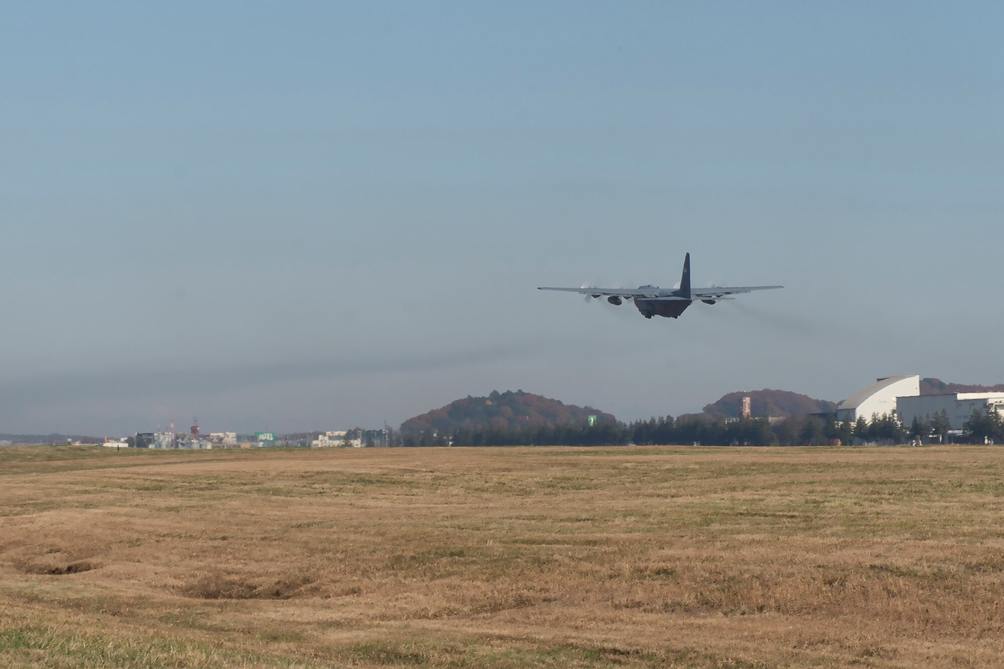 A C-130 Hercules leaves Yokota Air Base, Japan, Dec. 7, 2015 to participate in Operation Christmas Drop 2015. Over 40,000 pounds of goods will be dropped to 56 islands throughout the Commonwealth of the Northern Marianas, Federated States of Micronesia and Palau. (U.S. Air Force photo by Senior Airman David C. Danford/Released)