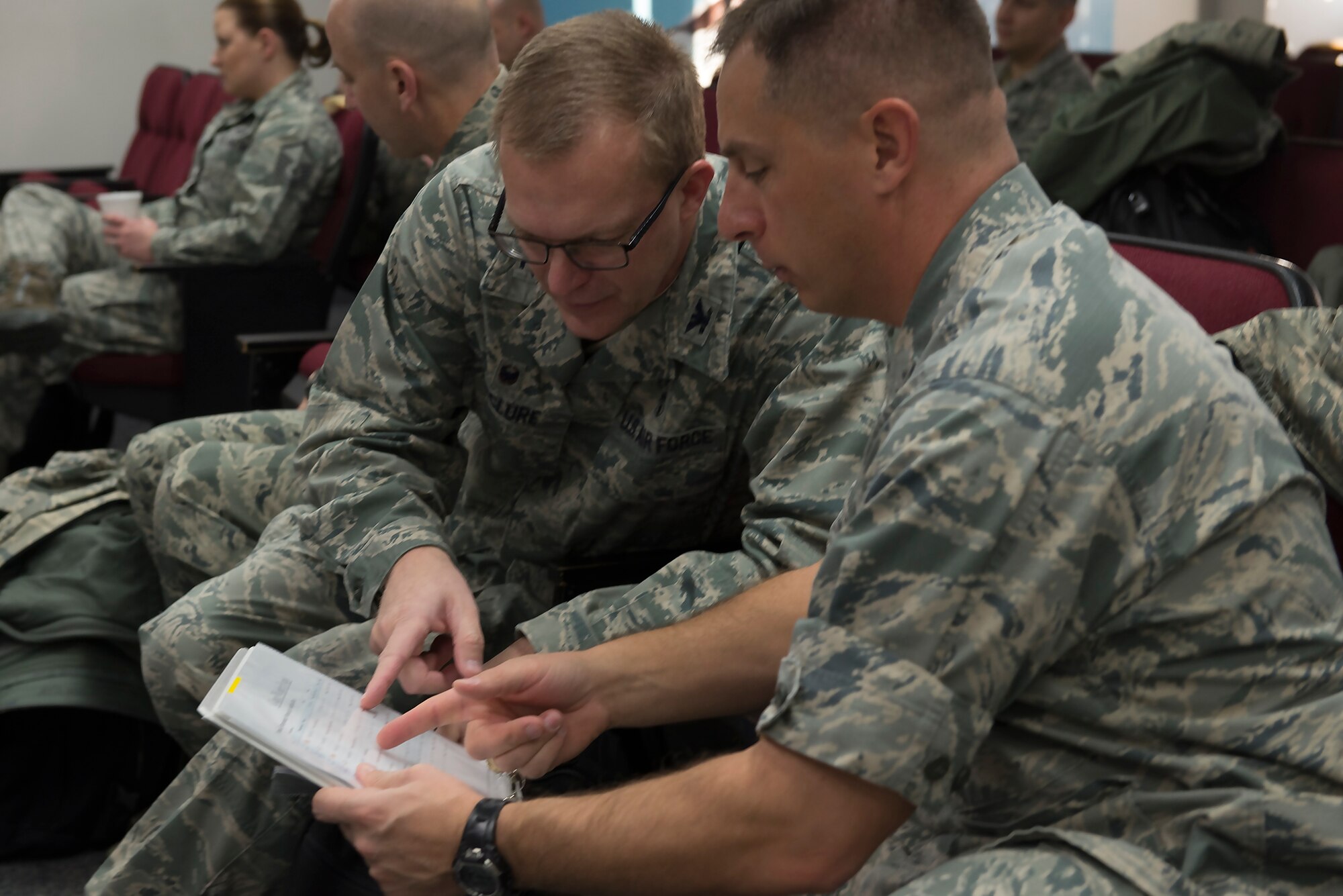 Col. Scott Maskery, 374th Mission Support Group commander, and Col. Richard McClure, 374th Dental Squadron commander, look over a pre-flight checklist prior to departing for their participation in Operation Christmas Drop 2015 at Yokota Air Base, Japan, Dec. 7, 2015. This year’s OCD will be the first to include trilateral training with air support from the Japan Air Self-Defense Force and Royal Australian Air Force. (U.S. Air Force photo by Senior Airman David C. Danford/Released)