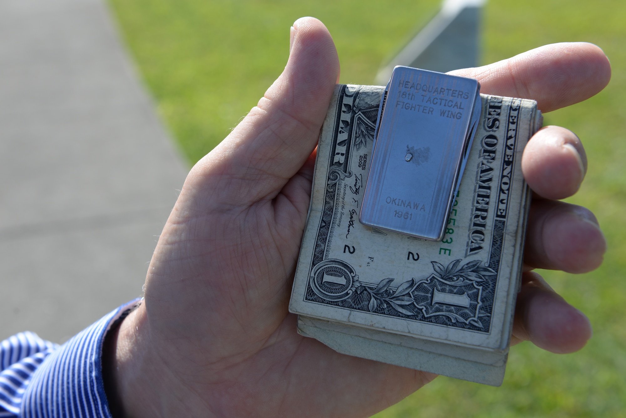 Retired U.S. Air Force Maj. Jim Bailey displays a money clip he has carried for more than 53 years, Oct. 20, 2015, at Kadena Air Base, Japan. Bailey received the money clip in 1961 as a prize for winning the Airman of the quarter award. (U.S. Air Force photo by Senior Airman Omari Bernard)