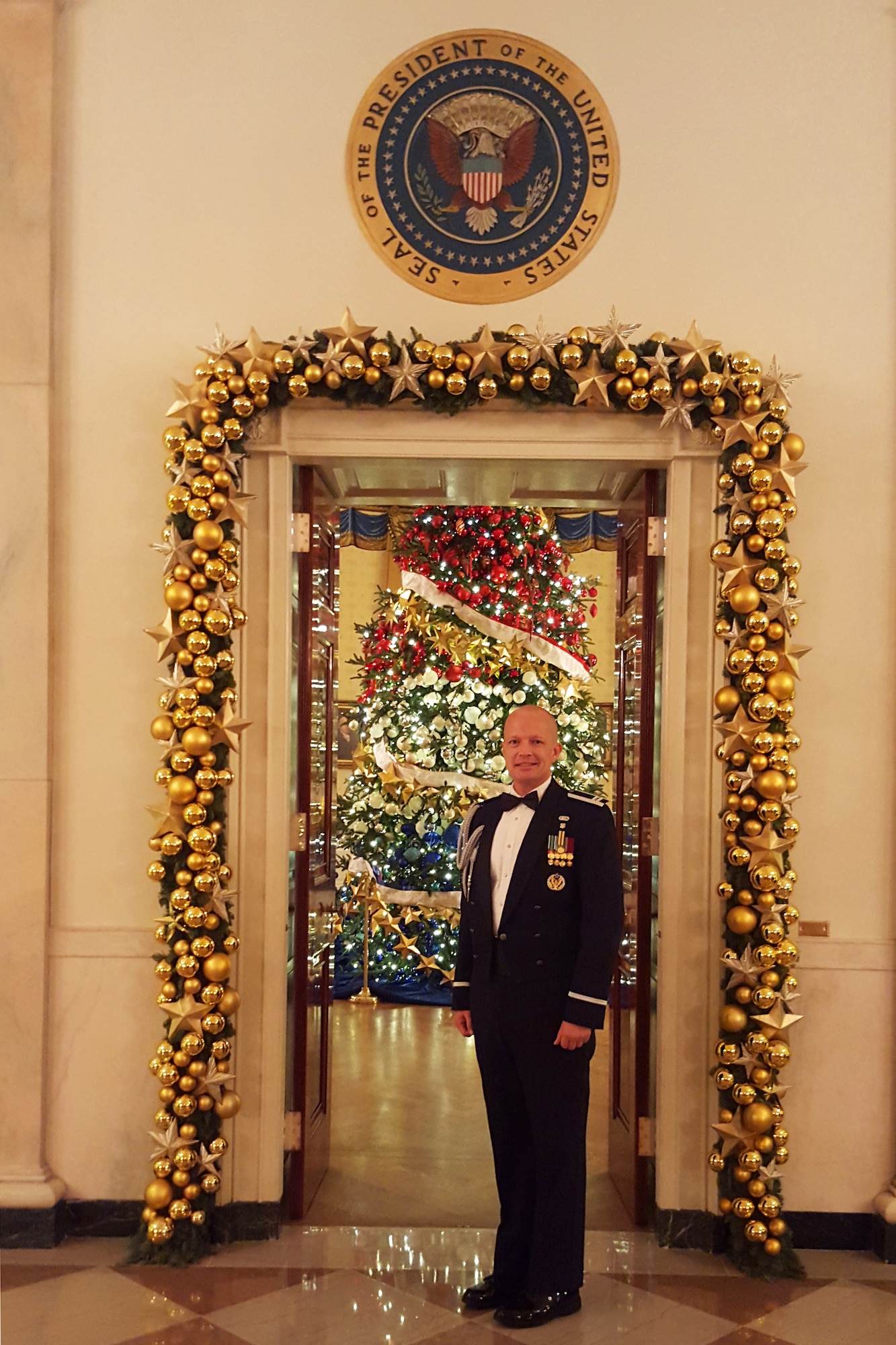 Air Force Capt. John D. Fesler stands in front of doorway to the Blue Room in Cross Hall of the White House. Fesler is the first Airman from the Air National Guard to serve as a White House social aide. (Photo courtesy of National Guard Bureau)