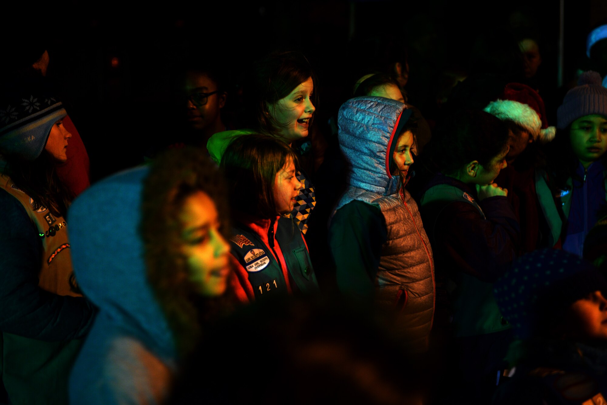 A group of Girl Scouts talk and laugh during a break from singing carols, Dec. 3, 2015, at the Christmas tree lighting ceremony on RAF Alconbury, United Kingdom. Events like this are hosted as a chance for Airmen and their families to strengthen resiliency this holiday season. (U.S. Air Force photo by Airman 1st Class Zachary Bumpus/Released)