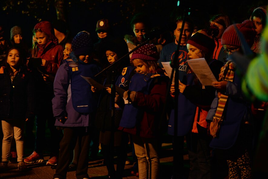 A group of Girl Scouts sing holiday carols, Dec. 3, 2015, during the Christmas tree lighting ceremony on RAF Alconbury, United Kingdom. The tree lighting gave families of the RAF Alconbury community an opportunity to come together and celebrate the beginning of the holiday season. (U.S. Air Force photo by Airman 1st Class Zachary Bumpus/Released)