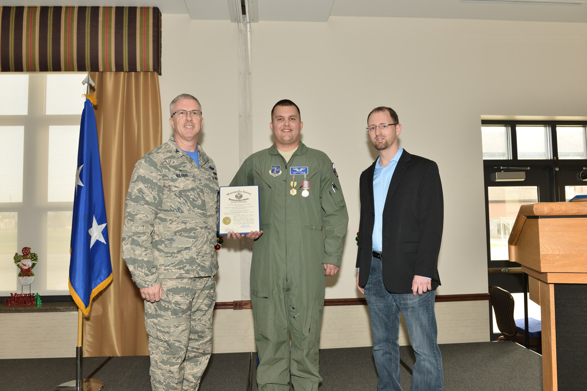 After receiving the Air Force Commendation Medal and the New York State Medal for Meritorious Service Dec. 6, 2015, Col. Robert Kilgore, Commander 107th Airlift Wing, poses with Tech. Sgt. Jason Oehlbeck who saved the life of Jack Ewald. (U.S. Air National Guard Photo/Senior Master Sgt. Ray Lloyd)