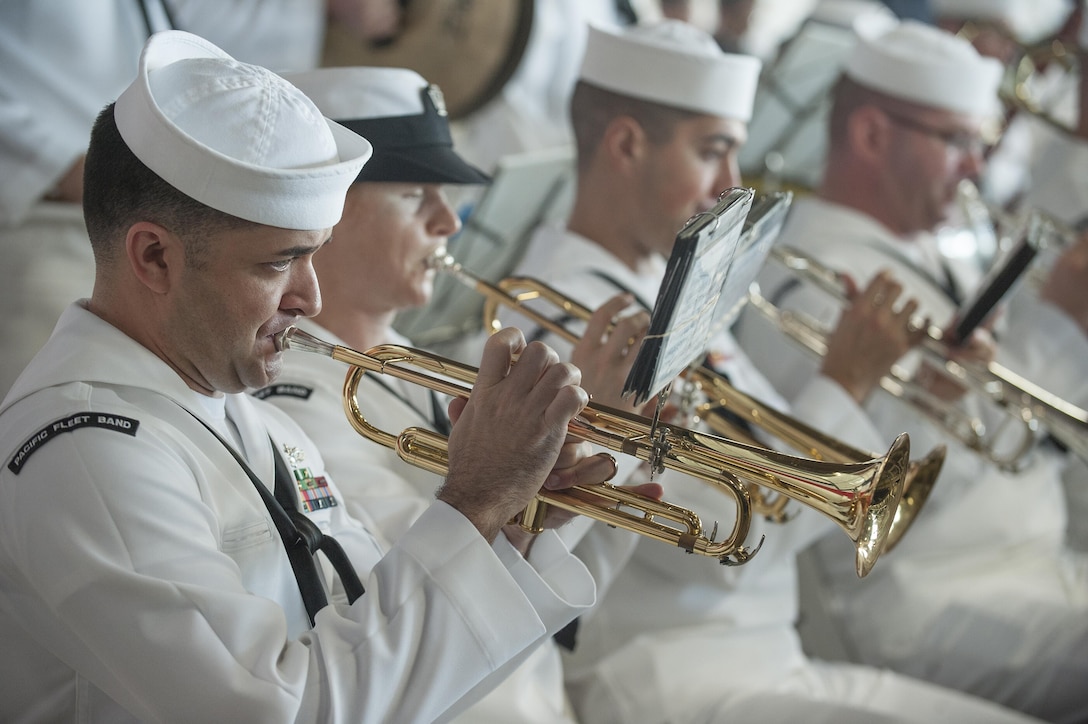 Navy Petty Officer 1st Class Brandon Barbie, left, performs with other band members during the 74th anniversary observance of the Dec. 7, 1941, Pearl Harbor attacks at Joint Base Pearl Harbor-Hickam, Hawaii, Dec. 7, 2015. Barbie is a trumpet musician assigned to U.S. Pacific Fleet Band. U.S. Air Force photo by Staff Sgt. Christopher Hubenthal