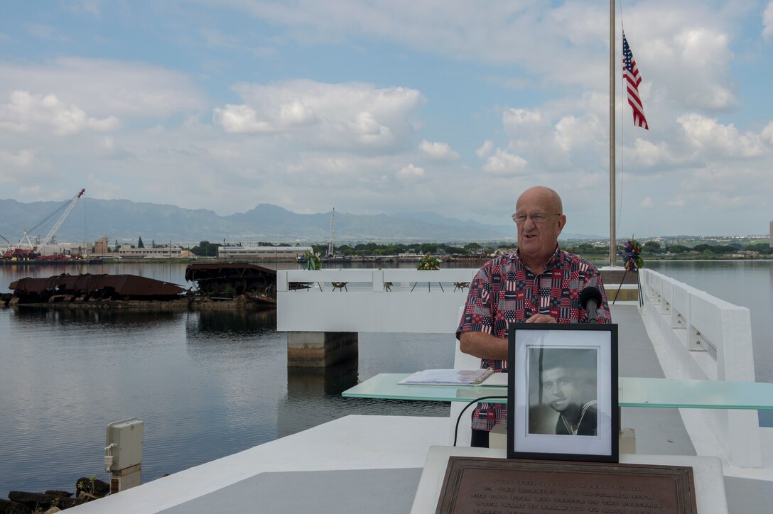 Retired Navy Master Chief Yeoman Jim Taylor, Pearl Harbor survivor liaison, initiates an ash-scattering ceremony in honor of retired Navy Chief boatswain's mate Donald Show, a USS Phoenix survivor, at the USS Utah Memorial during the Pearl Harbor Day commemoration anniversary at Joint Base Pearl Harbor-Hickam, Hawaii, Dec. 7, 2015. U.S. Navy photo by Petty Officer 3rd Class Katarzyna Kobiljak