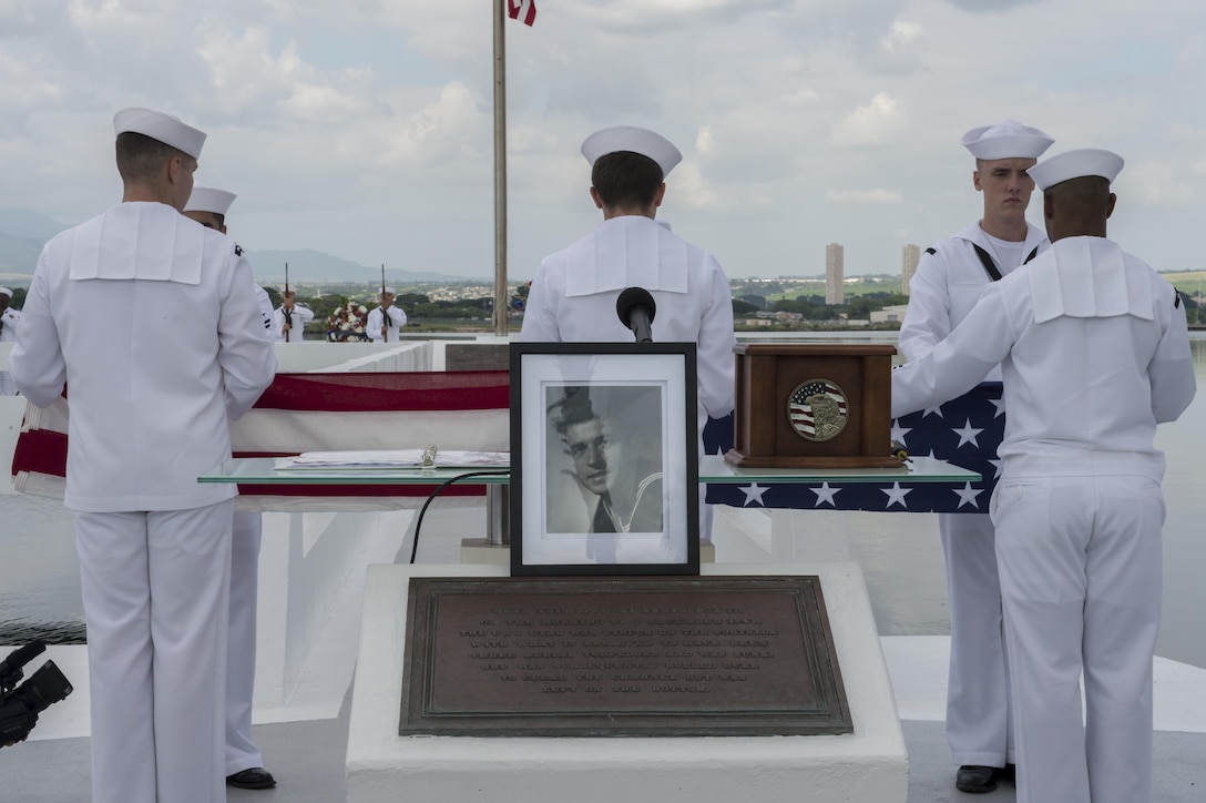 A photograph of retired Navy Chief boatswain's mate Donald Show, a USS Phoenix survivor, rests at a podium during an ash-scattering ceremony at the USS Utah Memorial during the Pearl Harbor Day commemoration anniversary at Joint Base Pearl Harbor-Hickam, Hawaii, Dec. 7, 2015. U.S. Navy photo by Petty Officer 3rd Class Katarzyna Kobiljak