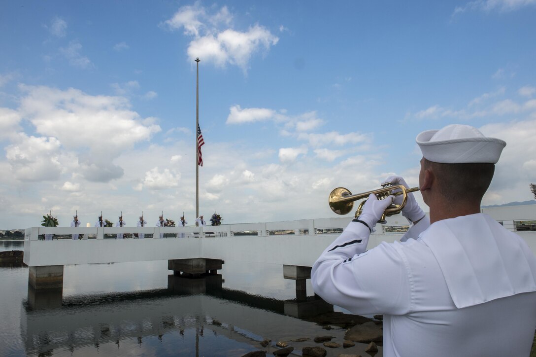 Navy Petty Officer 2nd Class Rick Baty plays taps on a bugle during an ash-scattering ceremony in honor of retired Navy Chief boatswain's mate Donald Show, a USS Phoenix survivor, at the USS Utah Memorial during the Pearl Harbor Day commemoration anniversary at Joint Base Pearl Harbor-Hickam, Hawaii, Dec. 7, 2015. Baty is a musician assigned to U.S. Pacific Fleet Band. U.S. Navy photo by Petty Officer 3rd Class Katarzyna Kobiljak