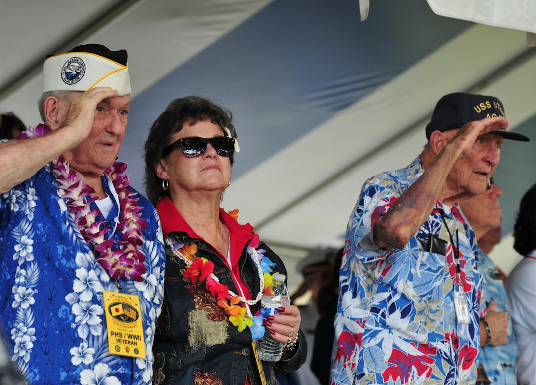 Pearl Harbor survivors render honors during a ceremony at the USS Oklahoma Memorial during a Pearl Harbor Day commemoration anniversary at Joint Base Pearl Harbor-Hickam, Hawaii, Dec. 7, 2015. U.S. Navy photo by Petty Officer 1st Class Rebecca Wolfbrandt