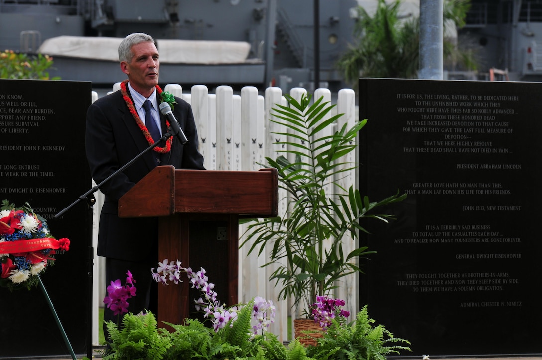 Jim Horton, director of the National Memorial Cemetery of the Pacific, speaks at the USS Oklahoma Memorial ceremony during a Pearl Harbor Day commemoration anniversary at Joint Base Pearl Harbor-Hickam, Hawaii, Dec. 7, 2015. U.S. Navy photo by Petty Officer 1st Class Rebecca Wolfbrandt 