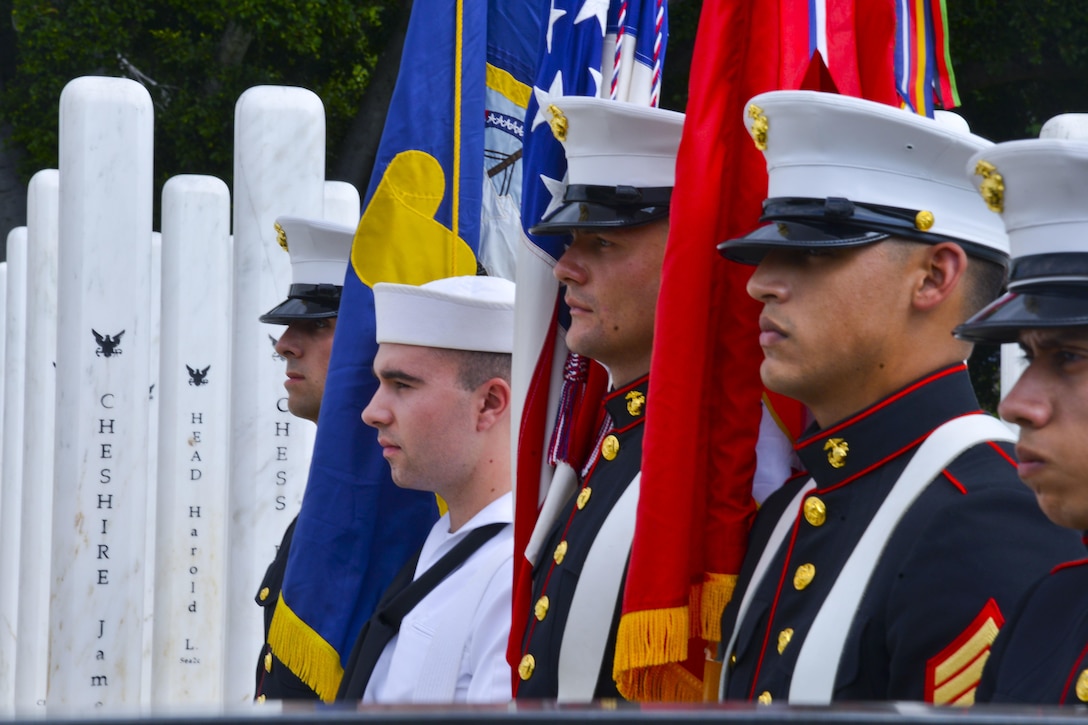 Service members of the Joint Base Pearl Harbor-Hickam color guard stand at attention at the USS Oklahoma Memorial during a Pearl Harbor Day Commemoration Anniversary at Joint Base Pearl Harbor-Hickam, Hawaii, Dec. 7, 2015. U.S. Navy photo by Petty Officer 1st Class Rebecca Wolfbrandt

