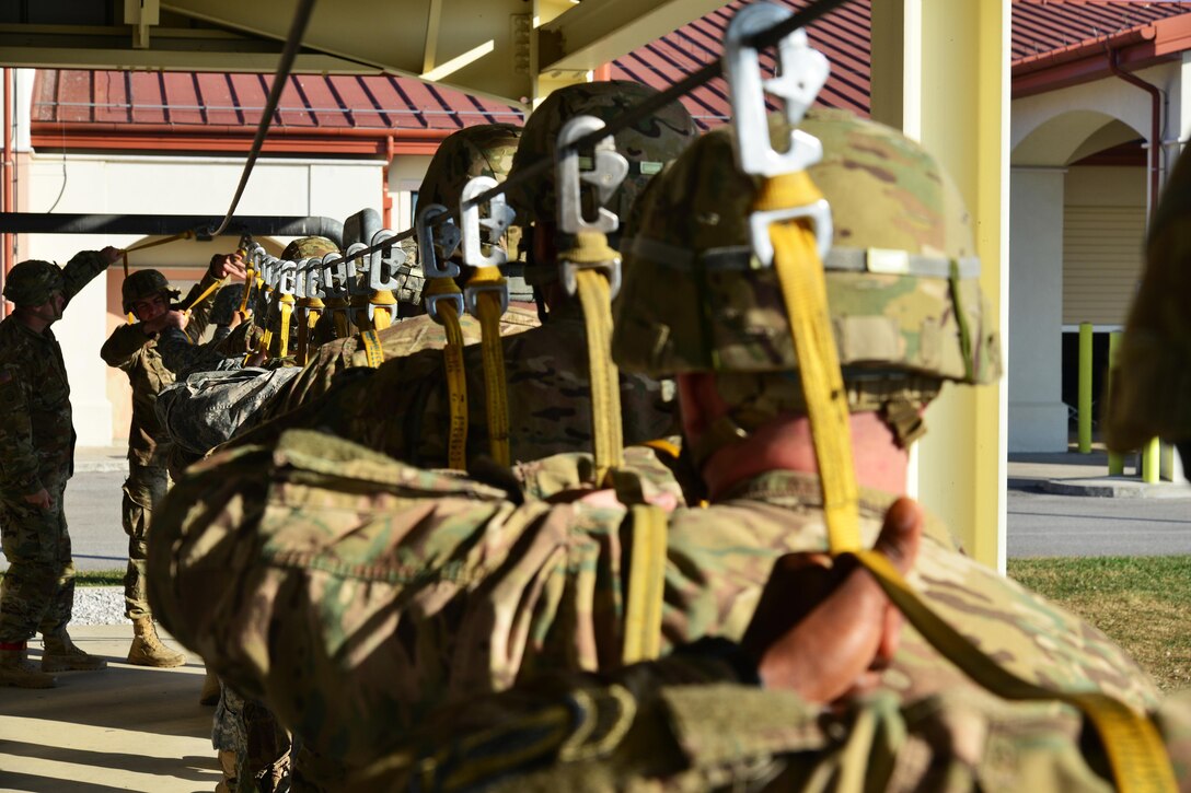 U.S. paratroopers await the mock door trainer at Aviano Air Base, Italy, in preparation for airborne operations onto Juliet drop zone in Pordenone, Italy, Dec. 2, 2015. U.S. Army photo by Paolo Bovo