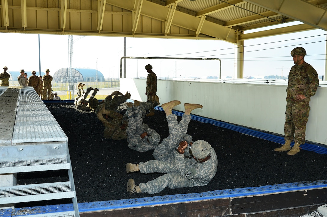 U.S. paratroopers rehearse parachute landing falls at Aviano Air Base, Italy, in preparation for airborne operations onto Juliet drop zone in Pordenone, Italy, Dec. 2, 2015. U.S. Army photo by Paolo Bovo