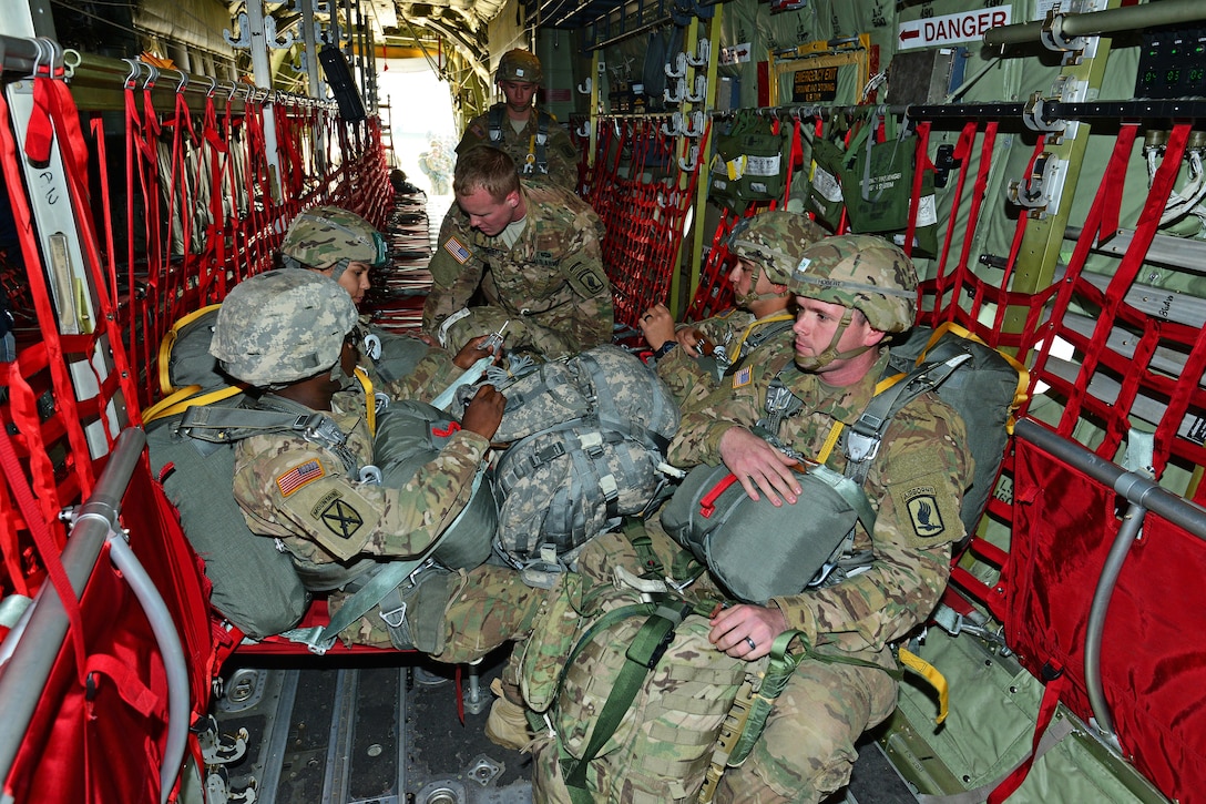 U.S. paratroopers sit inside a U.S. Air Force C-130 Hercules aircraft awaiting takeoff on Aviano Air Base, Italy, Dec. 2, 2015. U.S. Army photo by Paolo Bovo