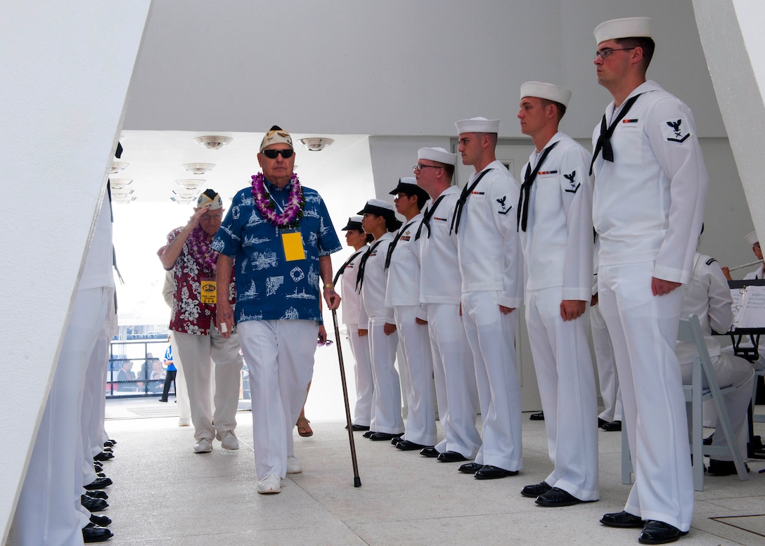 Survivors of the attacks on Pearl Harbor enter the USS Arizona Memorial for a wreath dedication ceremony to mark the 74th anniversary of the attacks, on Joint Base Pearl Harbor-Hickam, Hawaii, Dec. 7, 2015. U.S. Navy photo by Petty Officer 2nd Class Jeff Troutman