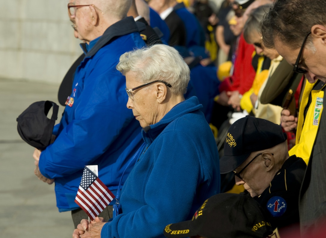 Esther Spring, who served in the Army Nurse Corps, and other World War II veterans bow their heads at the start of a Pearl Harbor remembrance ceremony at the National WWII Memorial on Dec. 7, 2015, in Washington, D.C. (U.S. Air Force photo/Sean Kimmons)