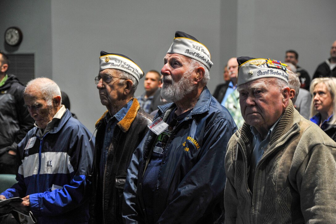 Pearl Harbor survivors sing “America the Beautiful” in the Naval Undersea Museum Jack Murdock Auditorium during the command's Annual Pearl Harbor Remembrance ceremony in Keyport, Wash., Dec. 7, 2015. U.S. Navy photo by Petty Officer 3rd Class Charles D. Gaddis IV