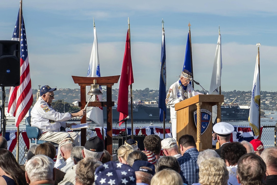 Ben Valeu, left, and Stu Hedley, both Pearl Harbor survivors, participate in a Pearl Harbor Remembrance ceremony aboard the USS Midway Museum in San Diego, California, Dec. 7, 2015. The bell is rung for the Two-Bell ceremony that honors Pearl Harbor survivors who have passed away this year. U.S. Navy photo by Petty Officer 3rd Class Gerald Dudley Reynolds