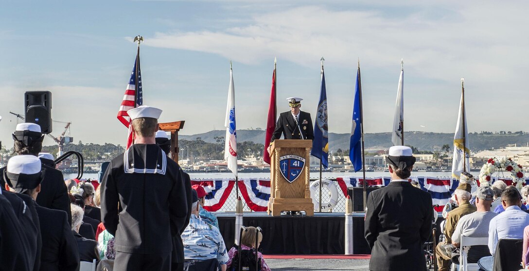 Navy Cmdr. Judd Krier, commander of the amphibious dock landing ship USS Pearl Harbor, gives a speech during a Pearl Harbor Remembrance ceremony aboard the USS Midway Museum in San Diego, California, Dec. 7, 2015. U.S. Navy photo by Petty Officer 3rd Class Gerald Dudley Reynolds
