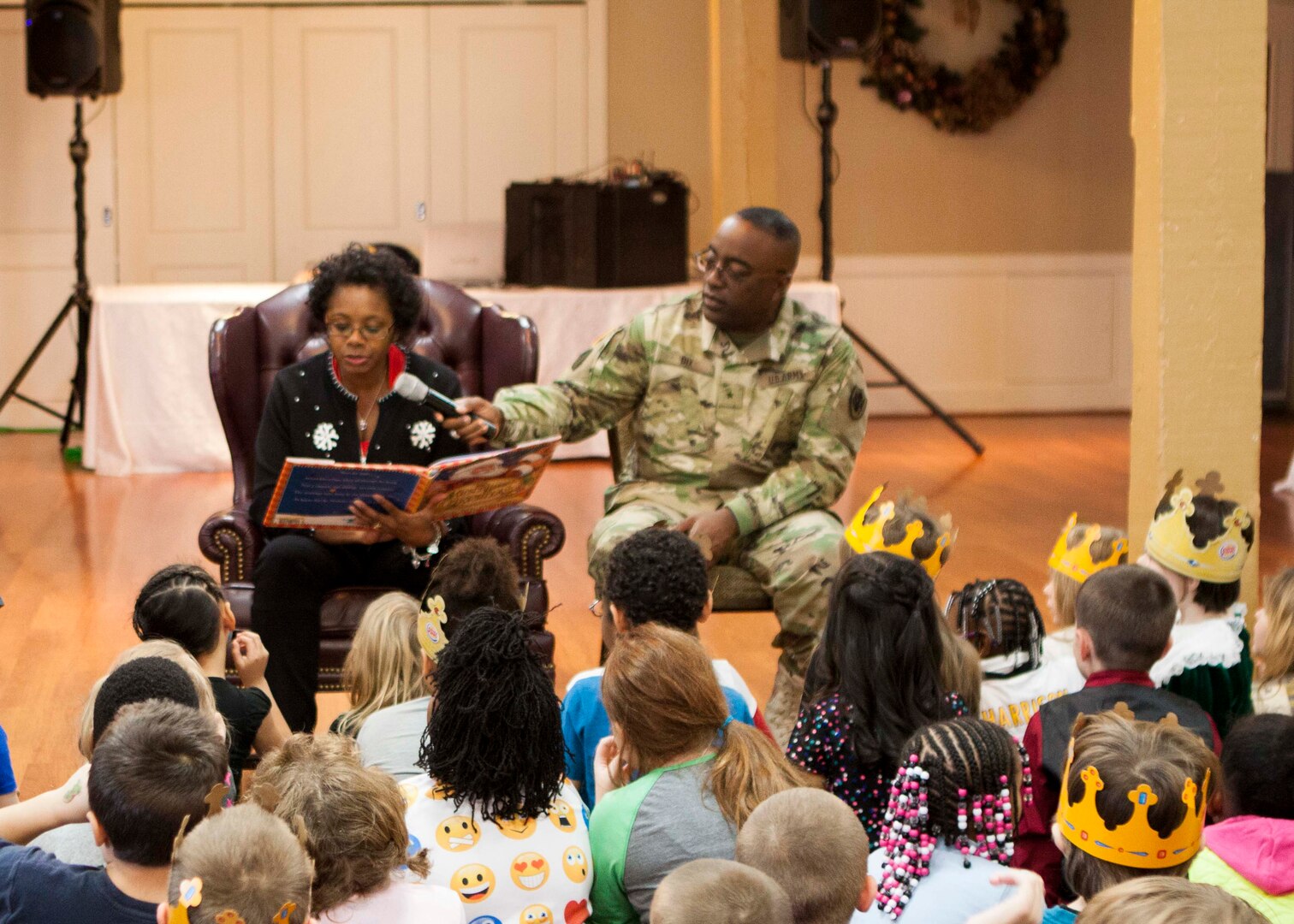 Children listen as Cynthia Dix, wife of DLA Distribution commander Army Brig. Gen. Richard Dix, reads the “The Night Before Christmas.”  