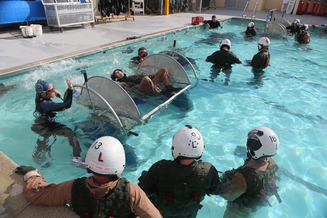 A student prepares to be dunked in the Modular Shallow Water Egress Trainer at the Aviation Water Survival Training Center aboard Marine Corps Air Station Miramar, Calif., Dec. 3. Aviation Water Survival Training is hosted every week, twice a week, and is mandatory for all pilots every four years. (U.S. Marine Corps Photo by Lance Cpl. Harley Robinson/Released)