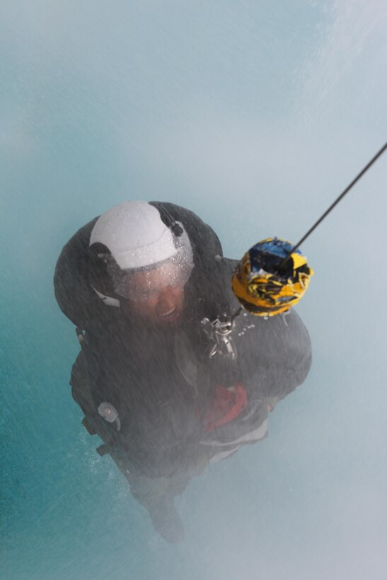 A student is lifted on a helicopter hoist simulator at the Aviation Water Survival Training Center aboard Marine Corps Air Station Miramar, Calif., Dec. 3. Water Survival Training is hosted every week, twice a week, and is mandatory for all pilots every four years. (U.S. Marine Corps Photo by Lance Cpl. Harley Robinson/Released)