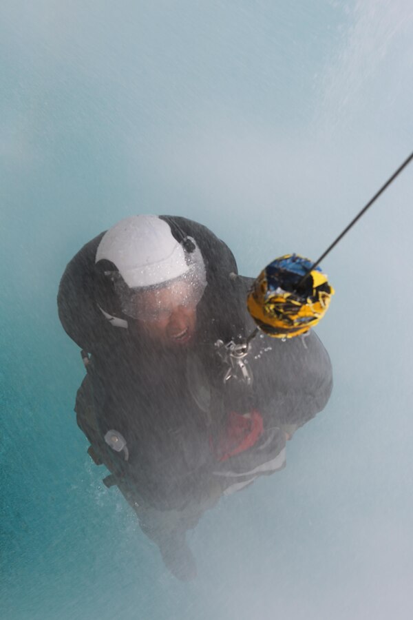 A student is lifted on a helicopter hoist simulator at the Aviation Water Survival Training Center aboard Marine Corps Air Station Miramar, Calif., Dec. 3. Water Survival Training is hosted every week, twice a week, and is mandatory for all pilots every four years. (U.S. Marine Corps Photo by Lance Cpl. Harley Robinson/Released)