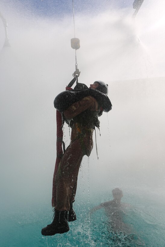 A student is lifted on a helicopter hoist simulator at the Aviation Water Survival Training Center aboard Marine Corps Air Station Miramar, Calif., Dec. 3. Aviation Water Survival Training is hosted every week, twice a week, and is mandatory for all pilots every four years. (U.S. Marine Corps Photo by Lance Cpl. Harley Robinson/Released)