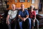 From left, Gaston Mean, an Awyaille, Belgium, resident for more than 70 years, sits with U.S. Air Force Chief Master Sgt. James McCloskey, and Mean's wife, in the living room of the Belgian home of the Mean family, Aug. 12, 2015.